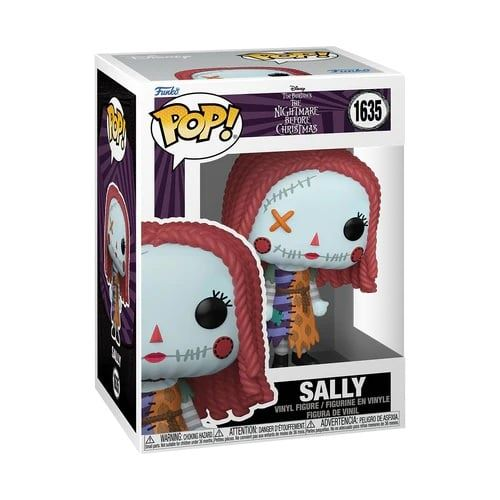 Una caja Funko Pop con una figura de Sally de The Nightmare Before Christmas. La figura tiene rasgos cosidos y cabello rojo.