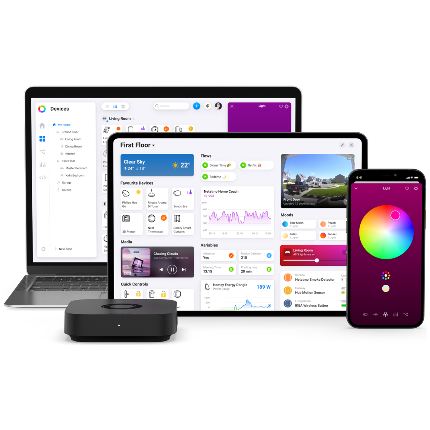 Smart home devices displayed on a laptop, tablet, and phone. A black hub sits in front.