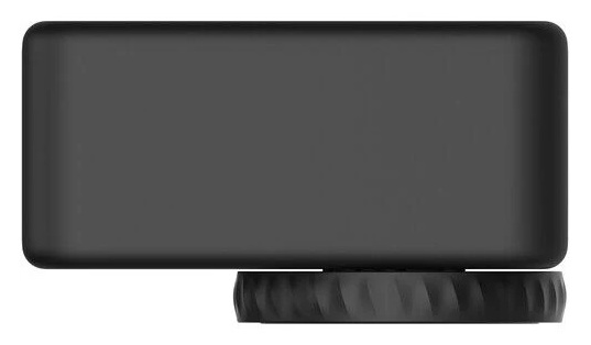 Czarny prostokątny obiekt z zaokrąglonymi rogami spoczywa na okrągłej, żłobionej podstawie. Obiekt jest w jednolitym, ciemnym kolorze.