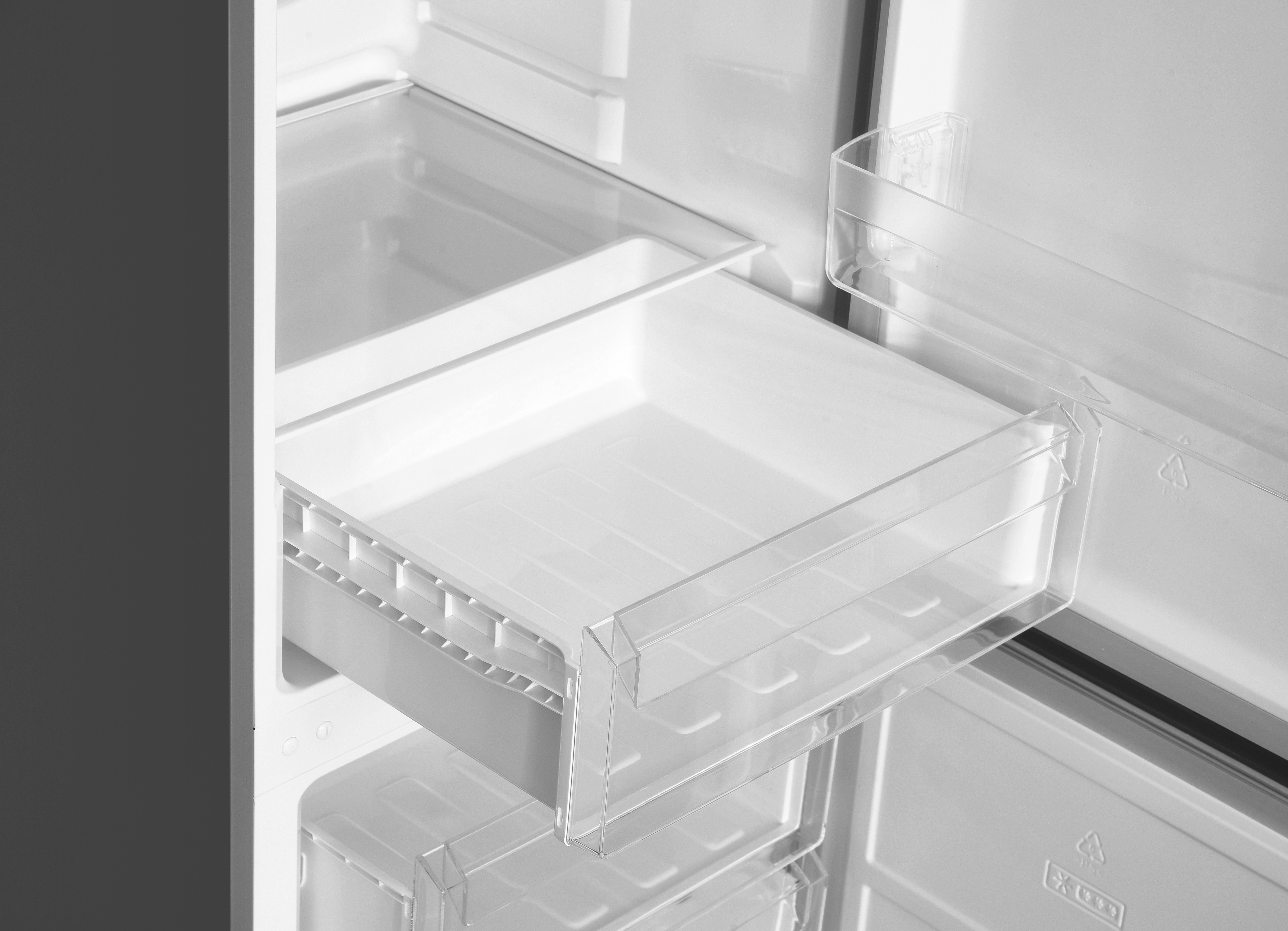 Inside a refrigerator, drawers and shelves are visible. The scene is white and gray, depicting the interior of a fridge.