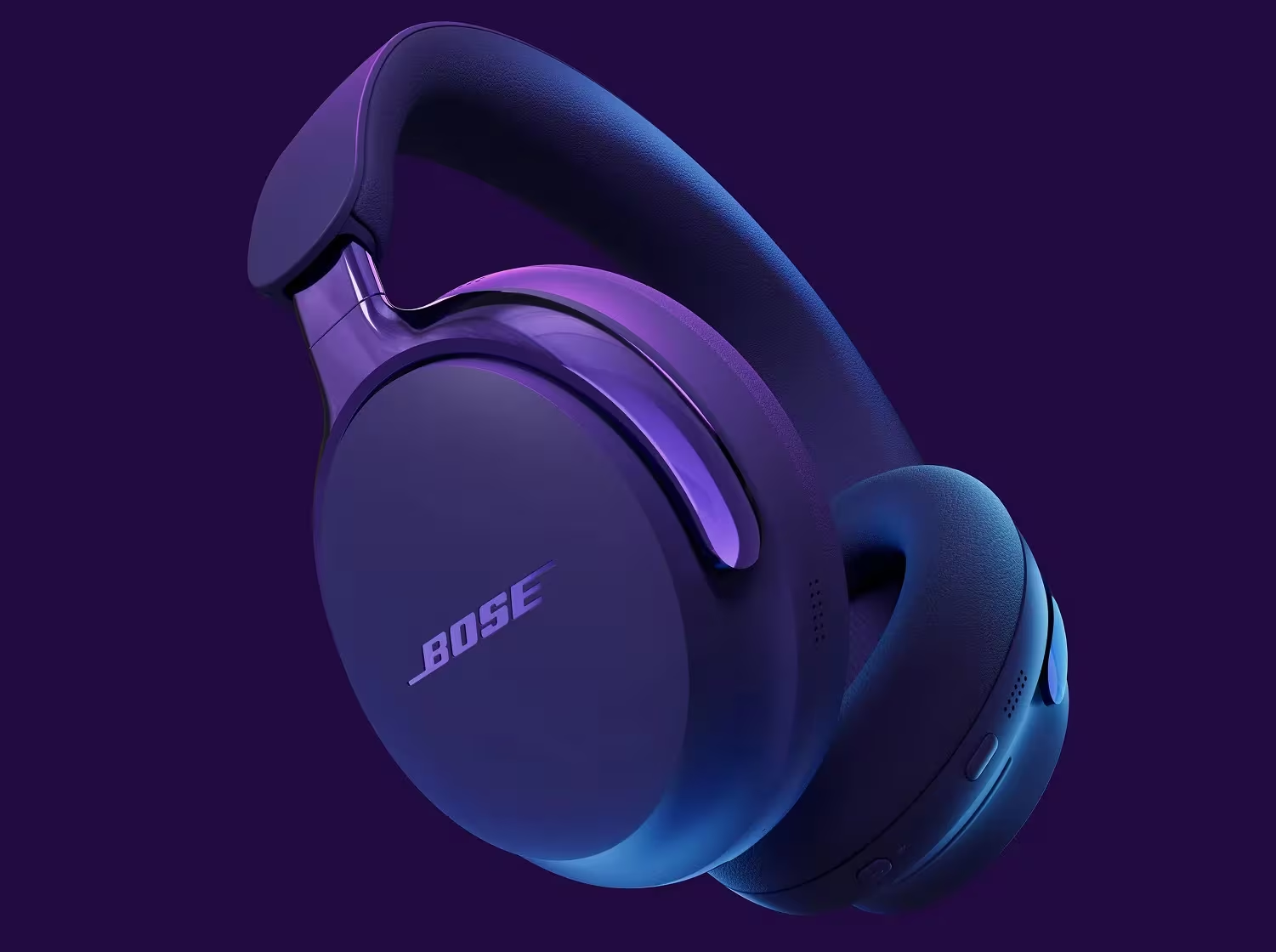 Une paire d'écouteurs Bose violets sur fond violet. Les écouteurs sont inclinés, montrant le logo et les écouteurs.