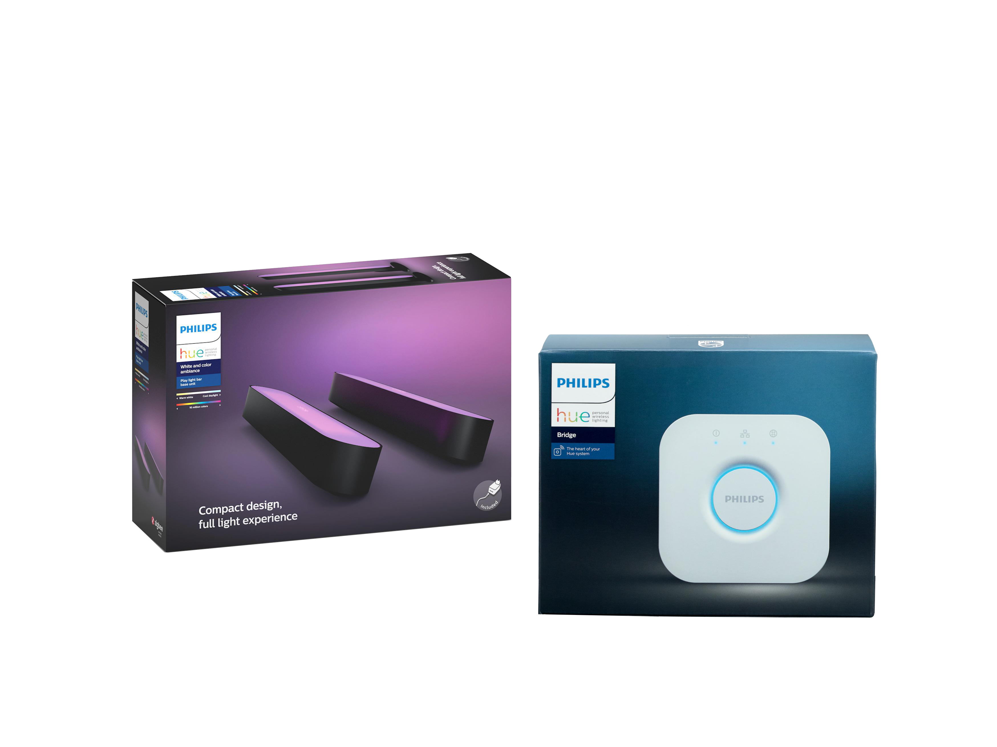Zwei Philips Hue Boxen. Eine zeigt Lichtleisten, die andere eine Brücke. Beide auf schwarzem Hintergrund.