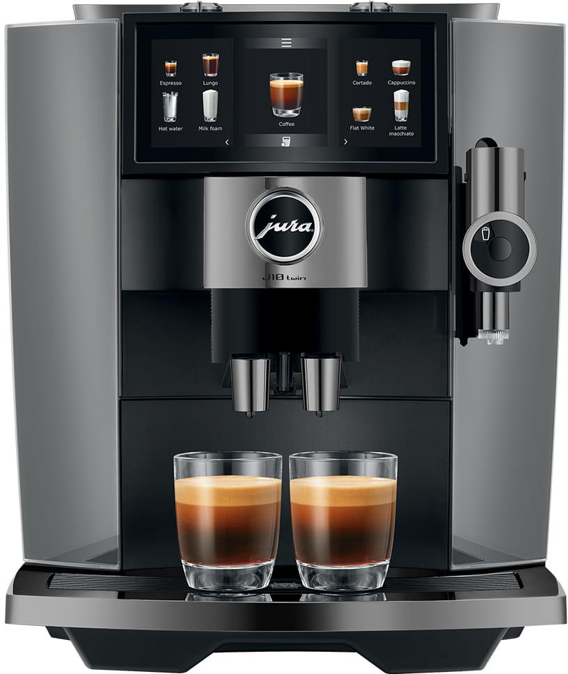 Eine Jura Kaffeemaschine mit Touchscreen und zwei Espressotassen. Der Bildschirm zeigt Kaffeeoptionen.