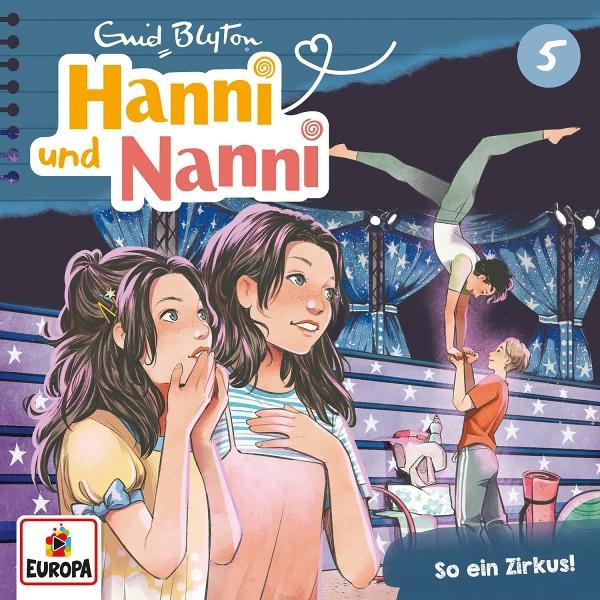 Buchcover mit zwei Mädchen, Zirkusartisten und Text auf Deutsch. Der Titel lautet "Hanni und Nanni".