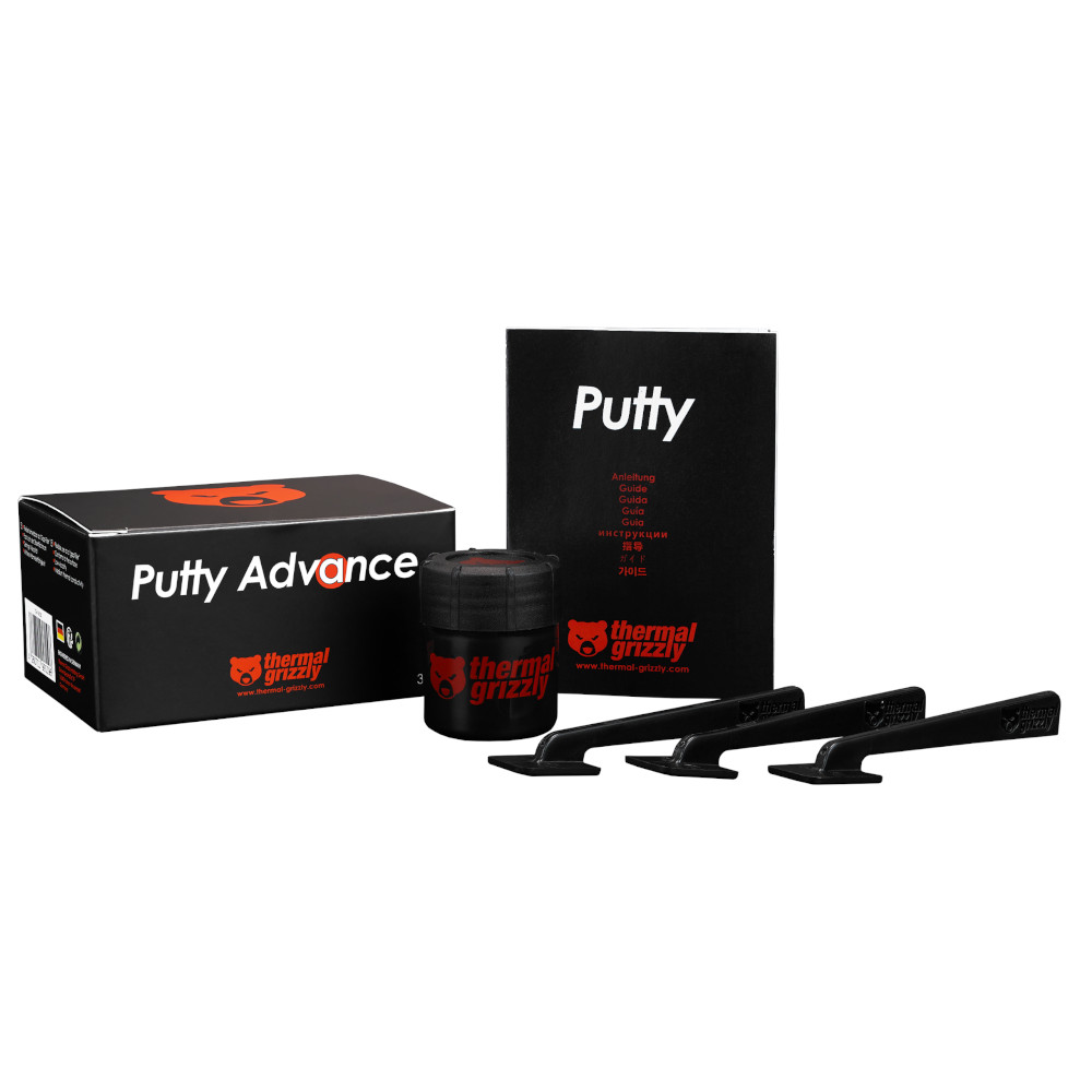 Eine schwarze Schachtel mit der Aufschrift 'Putty Advance', ein Tiegel mit Kitt, ein Heft und vier schwarze Applikationswerkzeuge.