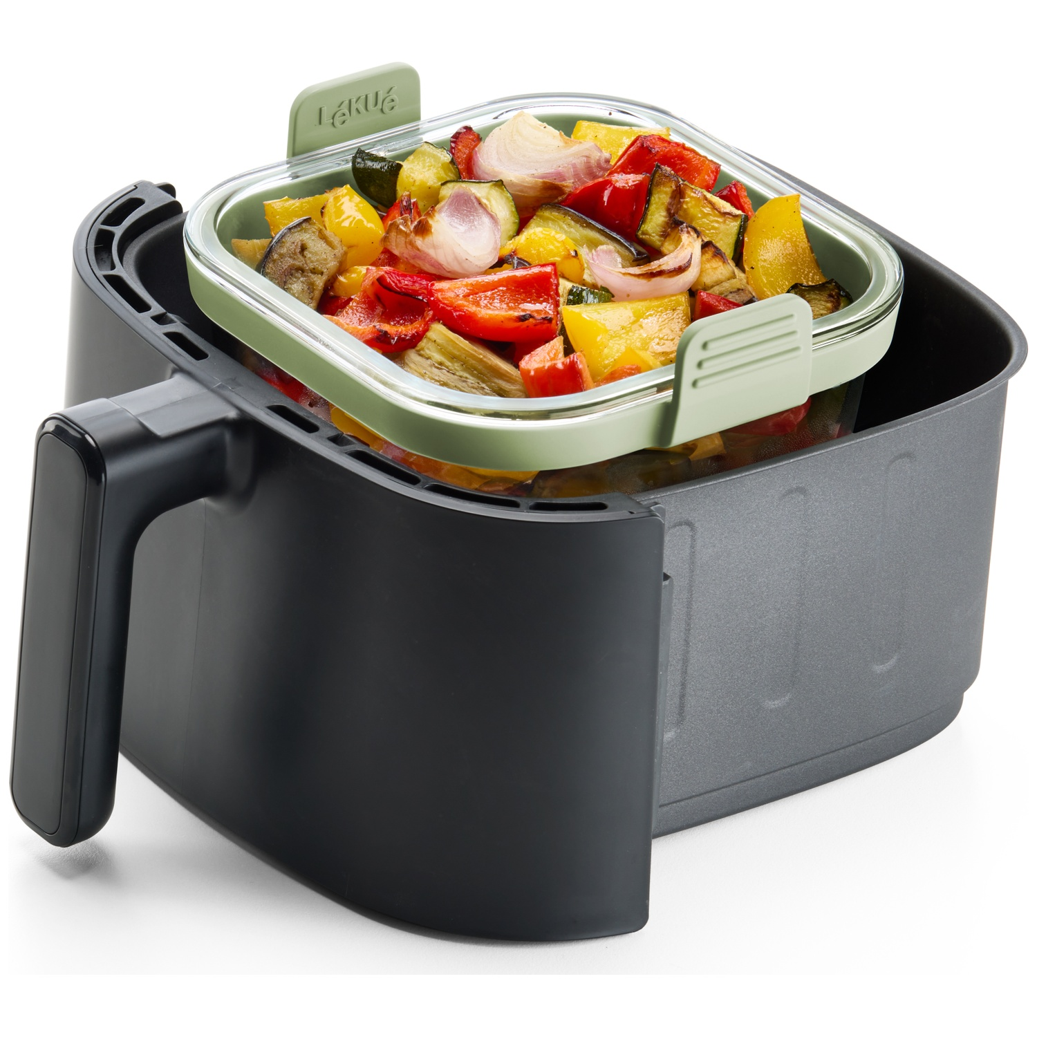 An air fryer with roasted vegetables inside a glass container. The vegetables are red, yellow, and green. The air fryer is black.