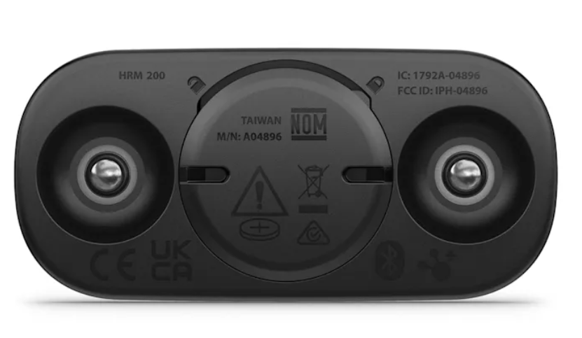 Czarna dolna część urządzenia z dwoma elementami przypominającymi głośniki, centralnym okrągłym obszarem z tekstem i symbolami.