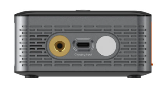 Zbliżenie szarego urządzenia z wieloma portami, w tym złotym, wejściem ładowania USB-C i białym przyciskiem.