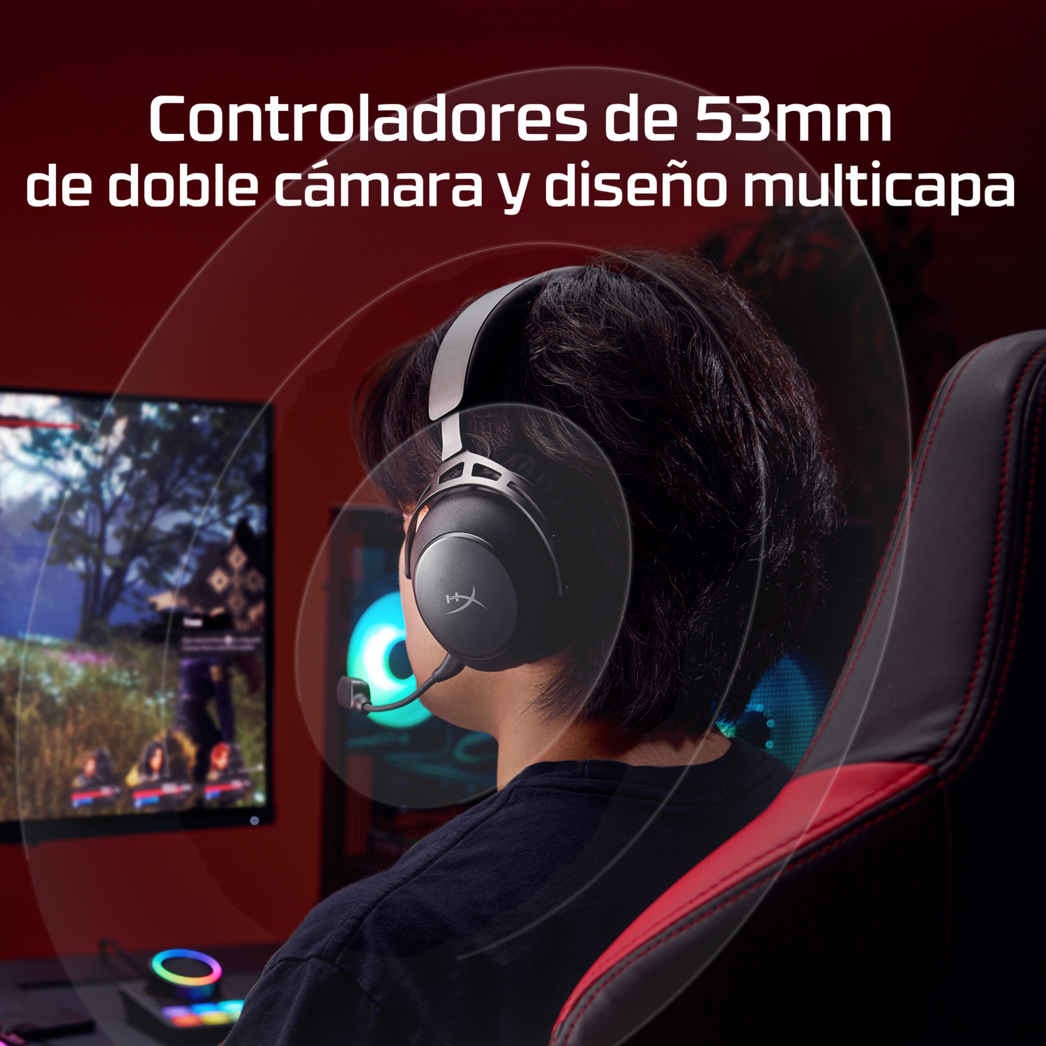 Una persona con auriculares está sentada en una silla de juego. Un monitor y un panel de control son visibles en el fondo.