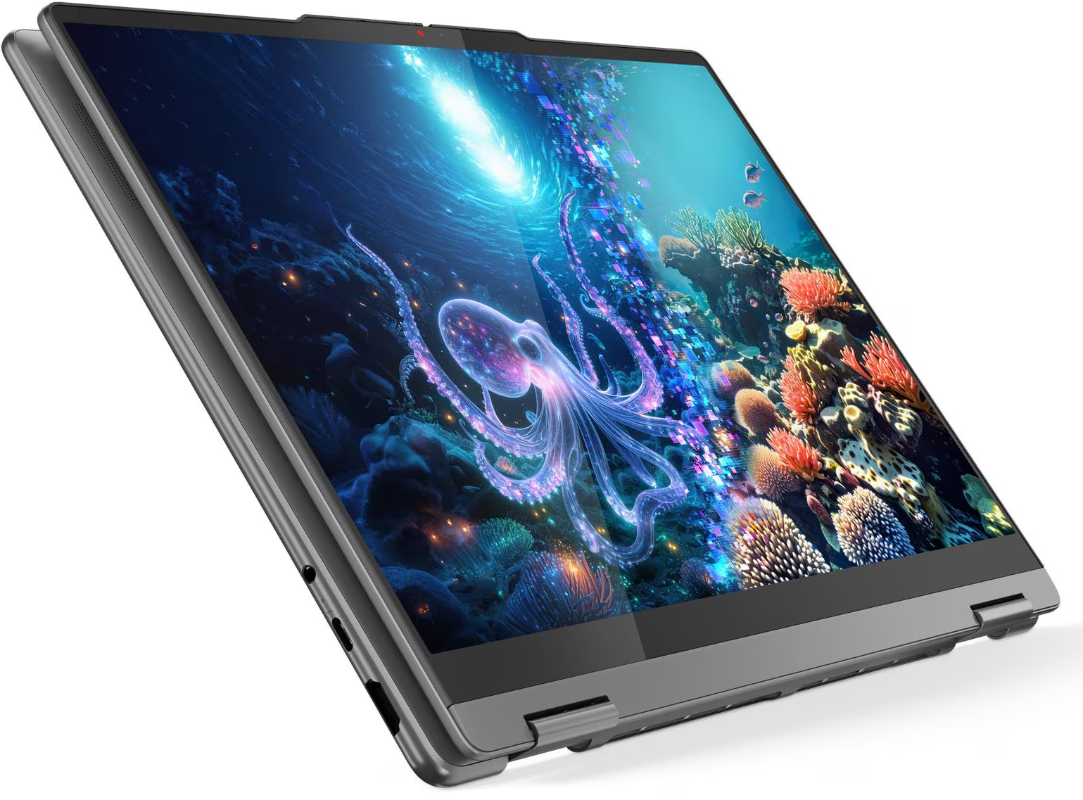 A laptop képernyője egy víz alatti jelenetet jelenít meg egy polippal. Színes korallok és halak láthatók.