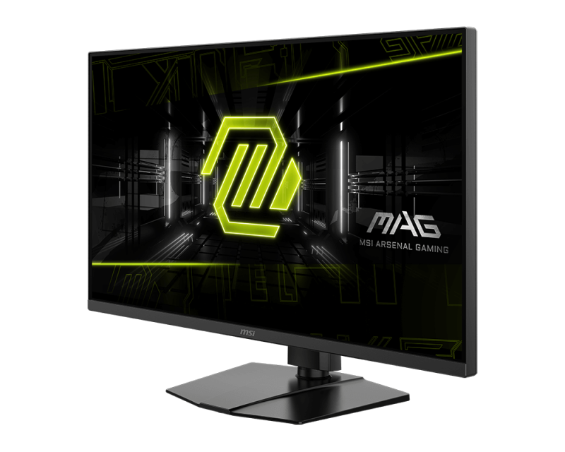 MSI gamer monitor. Fekete keret, fekete állvány. A képernyő zöld geometriai dizájnt és MSI MAG logót jelenít meg. Fekete háttér.