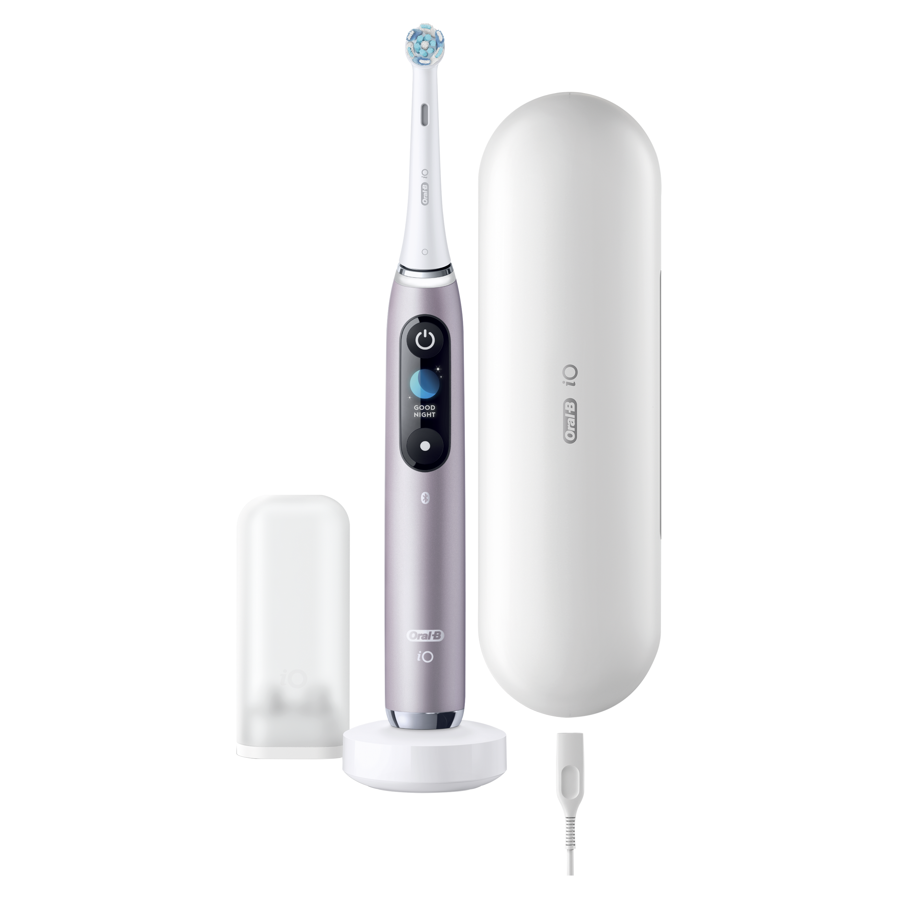 Szczoteczka elektryczna, etui, stacja ładująca i kabel. Szczoteczka jest fioletowa, etui białe.