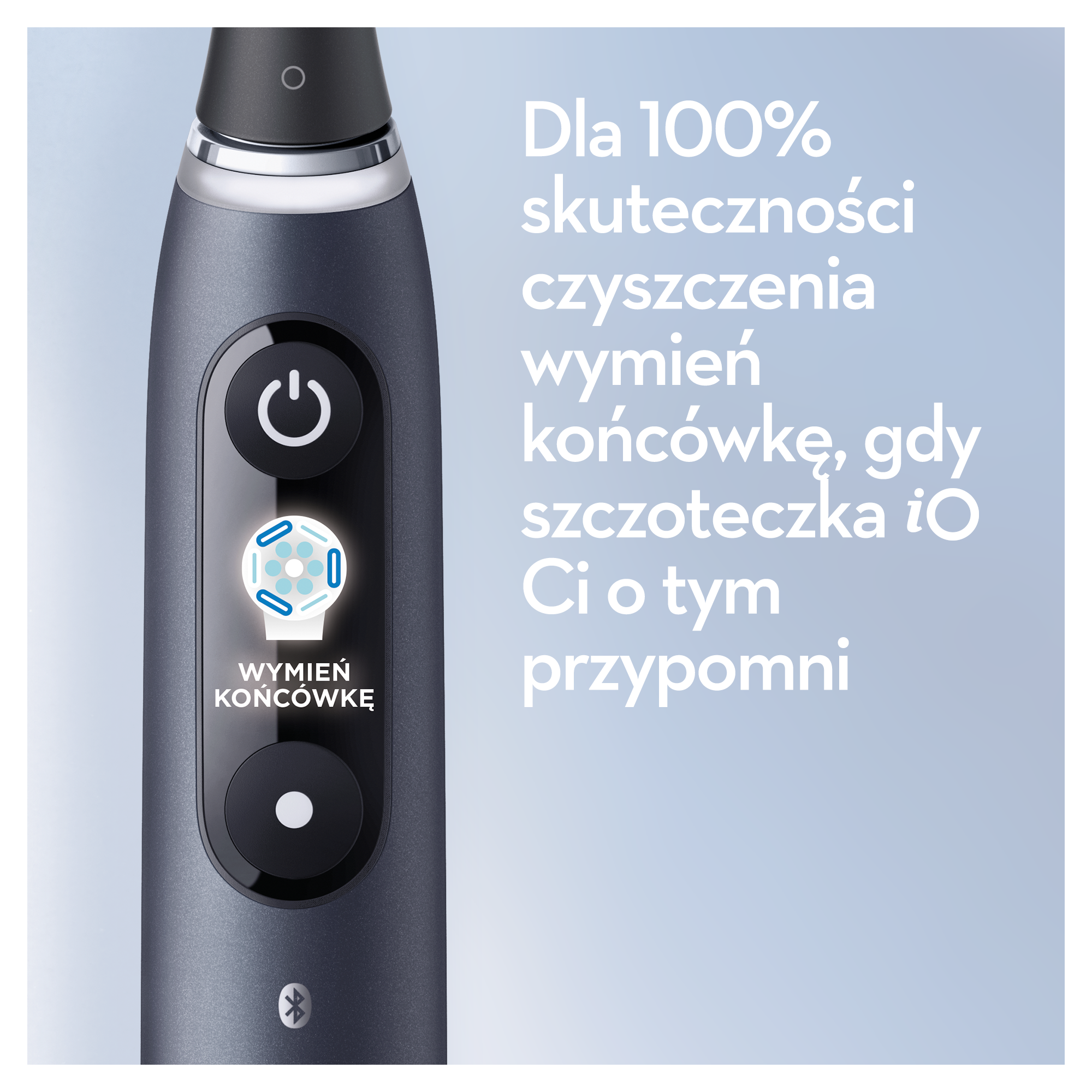 Szczegół szczoteczki elektrycznej z przyciskiem zasilania, wskaźnikiem wymiany głowicy i polskim tekstem na niebieskim tle.