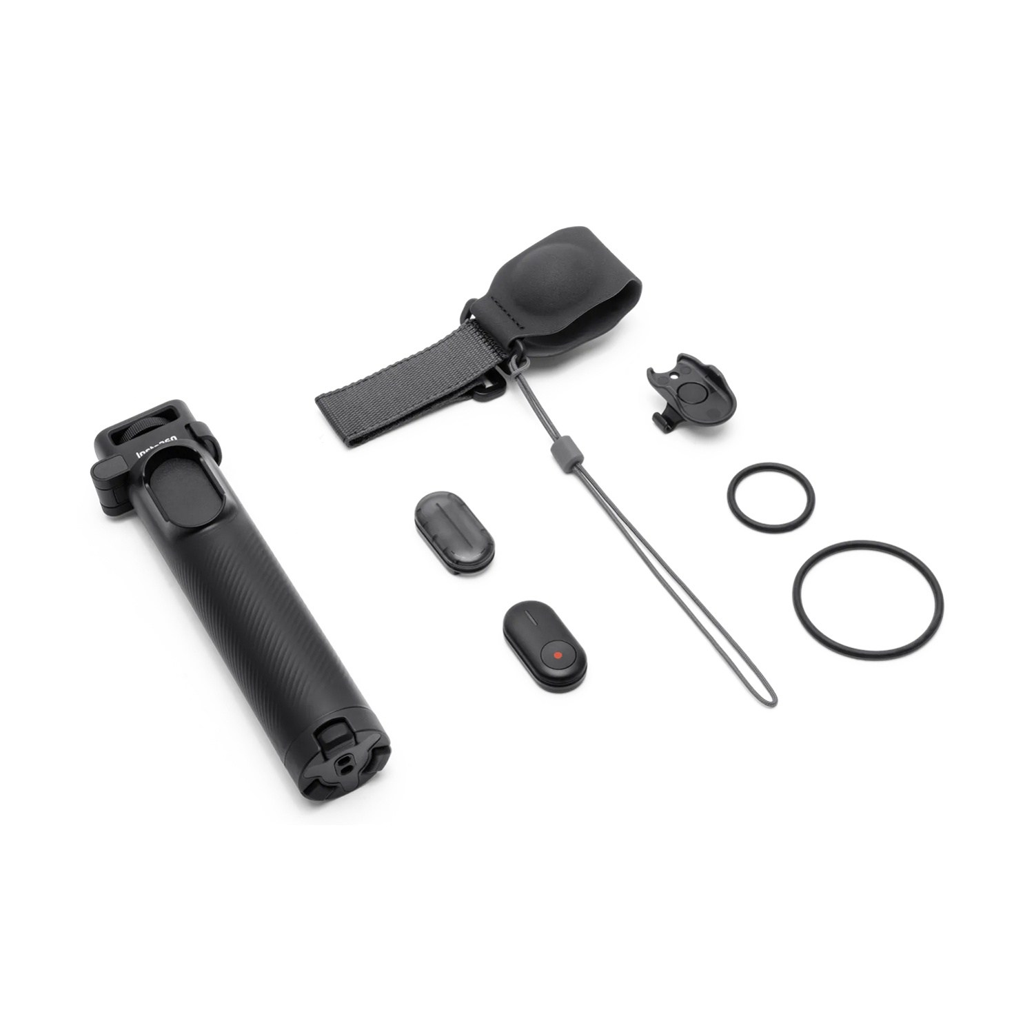 Impugnatura per fotocamera nera e accessori su bianco. Include cinturino da polso, telecomando e anelli.