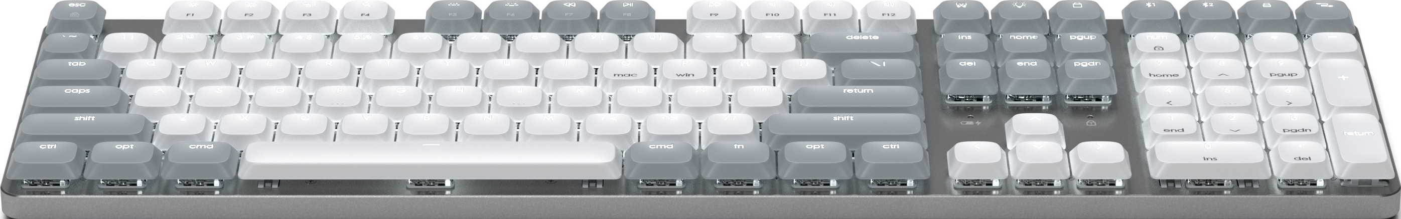 Eine weiße und graue mechanische Tastatur mit verschiedenen Tasten und Symbolen auf einer grauen Oberfläche.