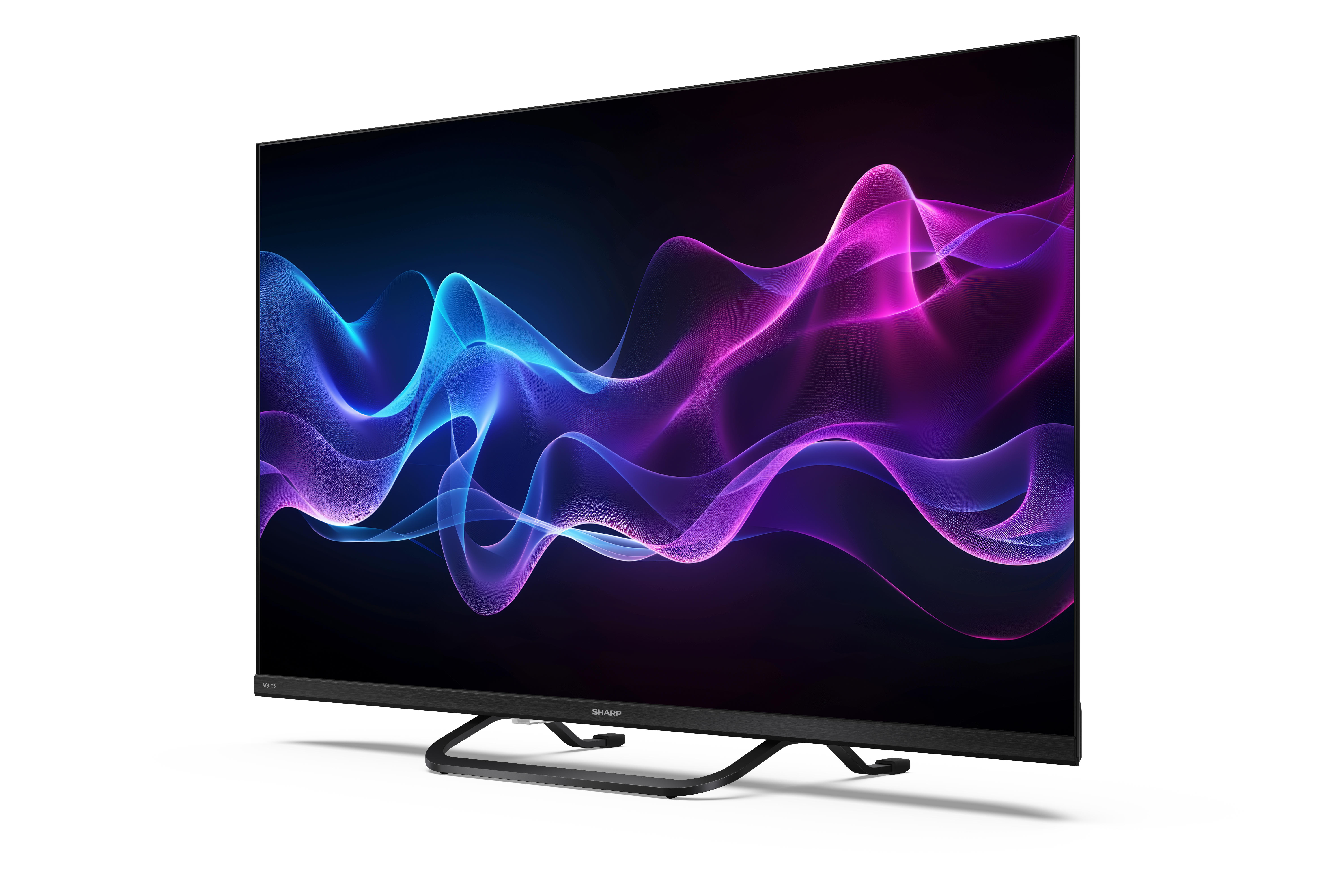 A Sharp TV egy absztrakt, színes mintát jelenít meg. Fekete kerettel és állvánnyal rendelkezik, fehér háttér előtt.