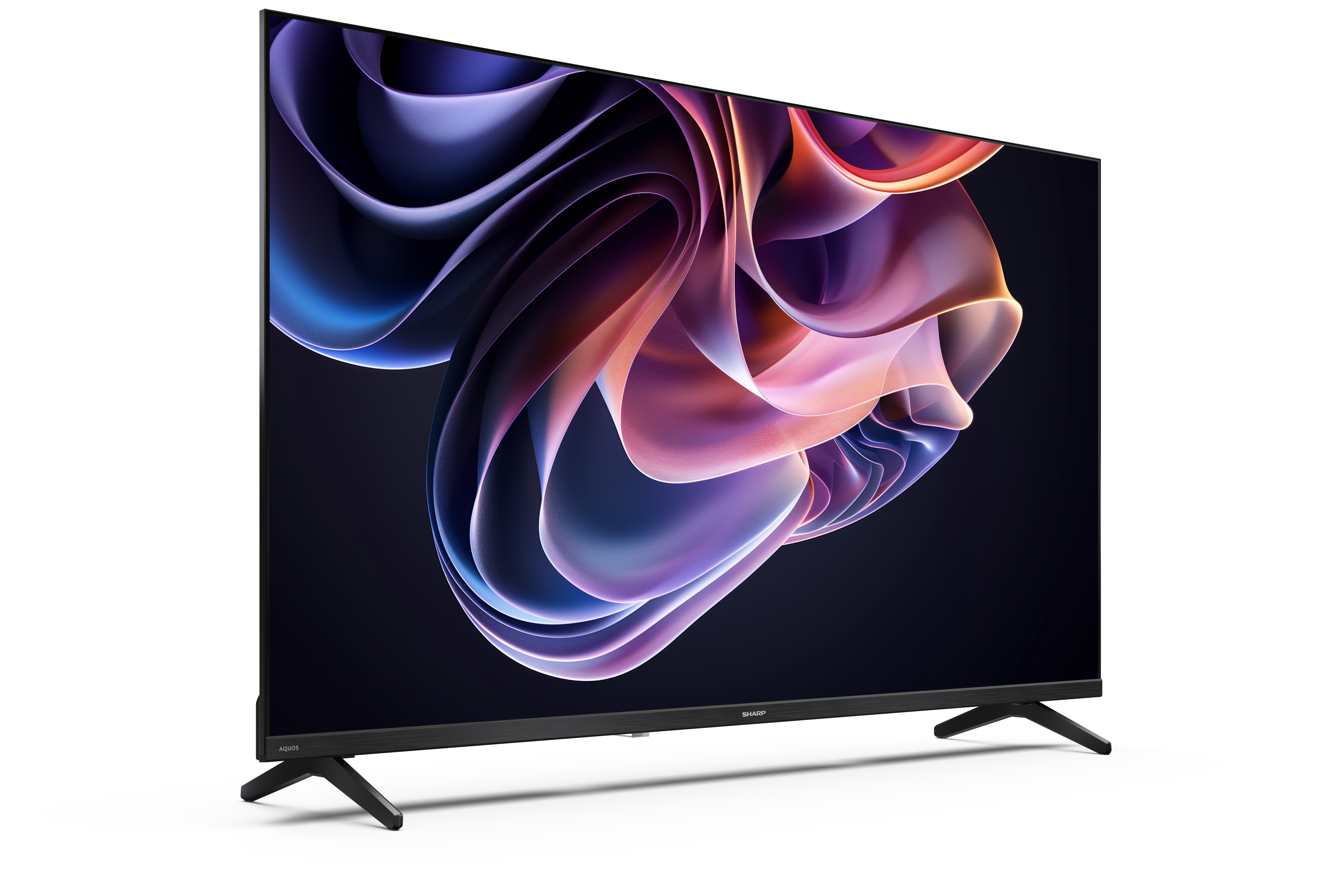 Egy Sharp Aquos TV fekete kerettel és állvánnyal. A képernyő színes absztrakt képet jelenít meg.