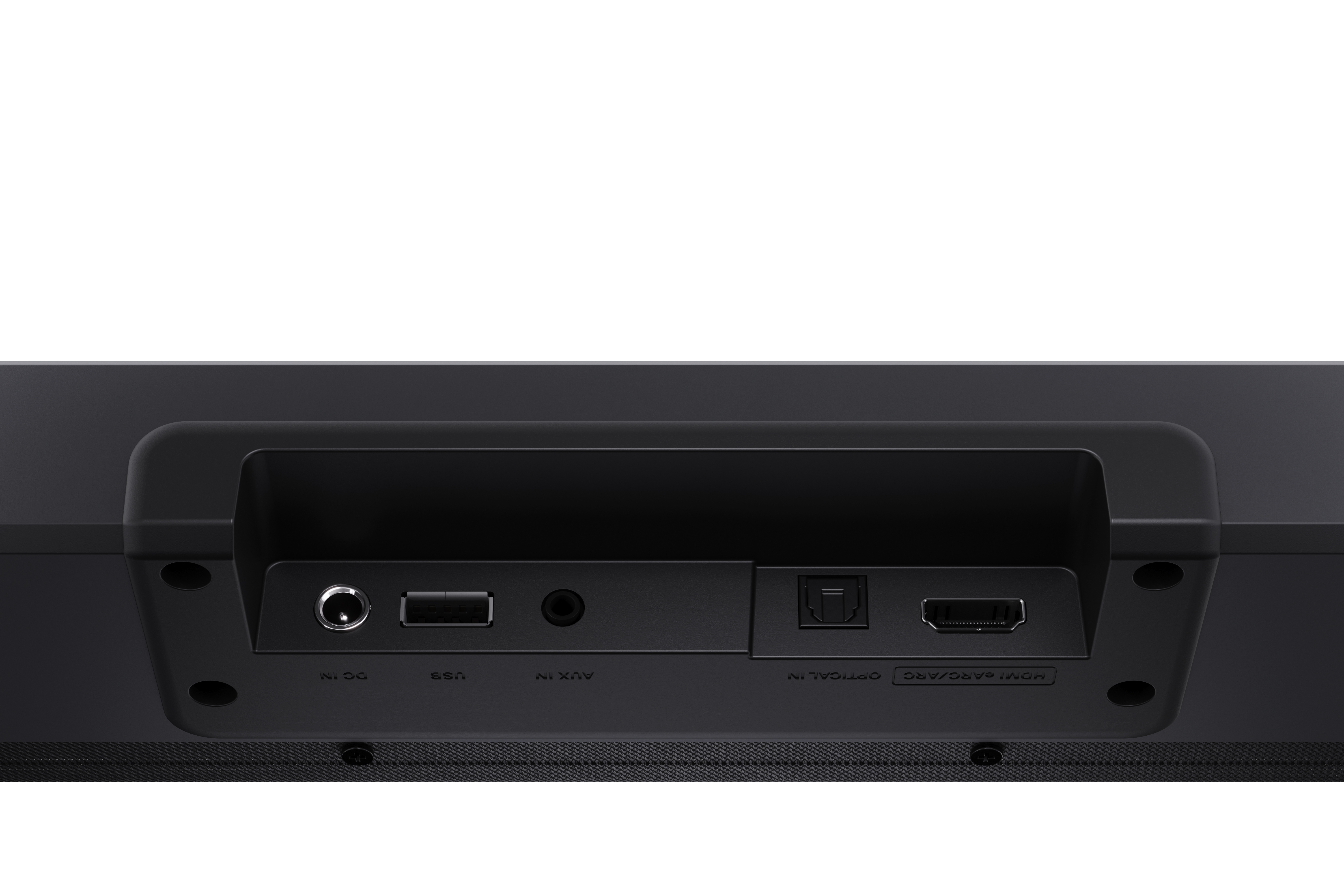 Egy fekete soundbar hátuljának közeli képe. Különböző bemeneti portjai vannak: DC, USB, AUX, optikai és HDMI ARC.