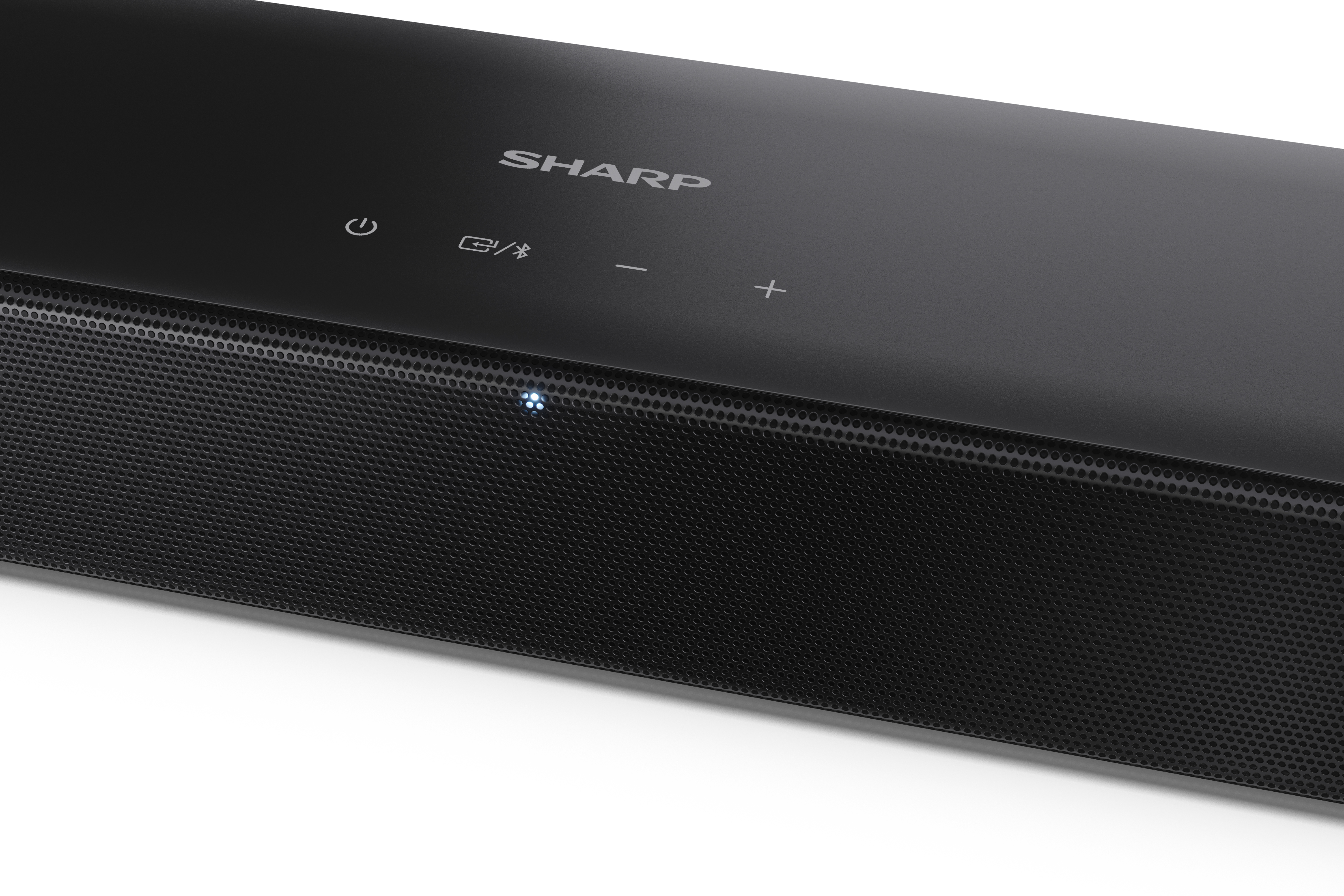 Fekete soundbar a tetején a 'SHARP' márkával. Van bekapcsoló és hangerő gomb. Hálós hangszóró borítás.