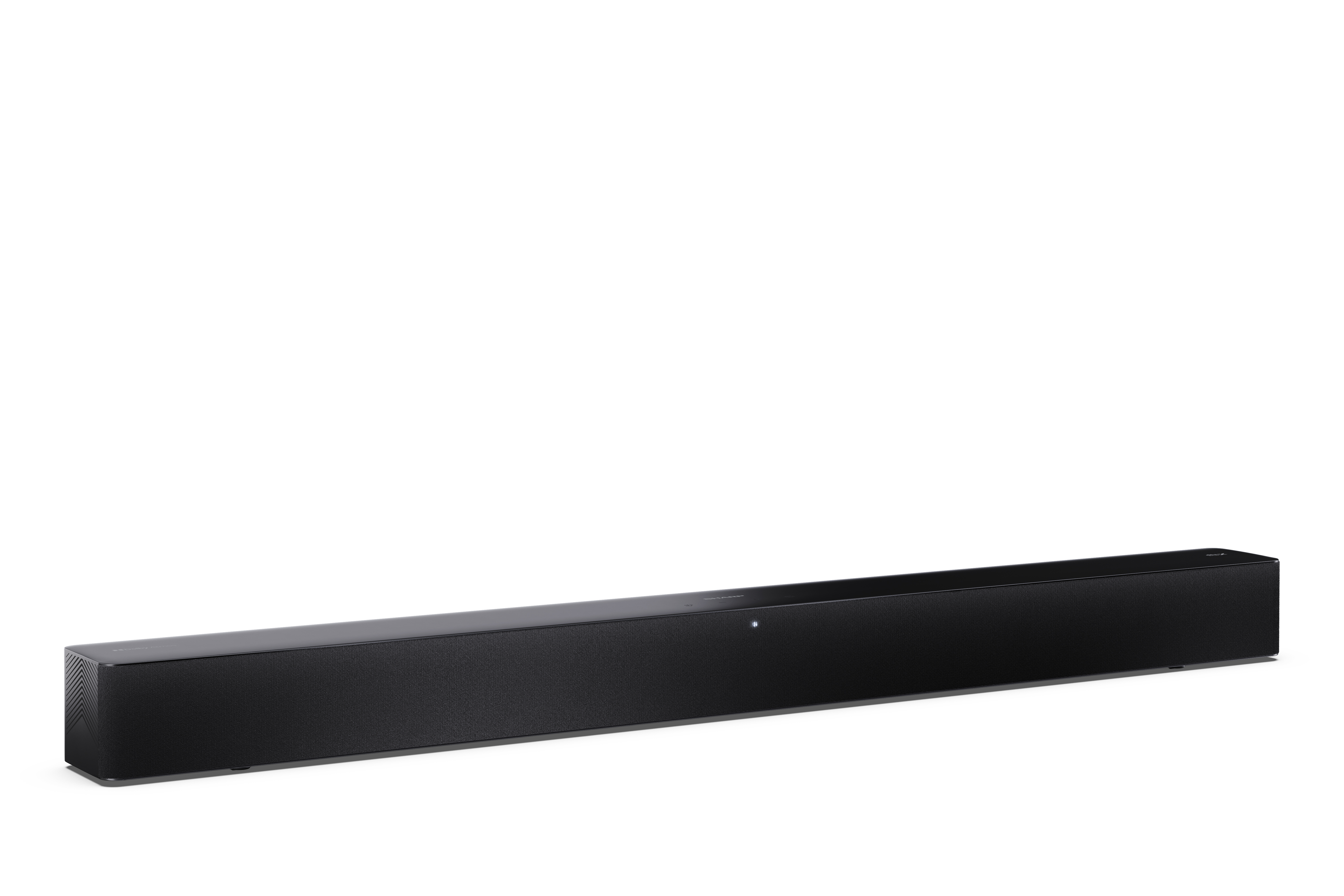 Egy fekete soundbar fehér felületen. Hálós előlapja és fényes teteje van.