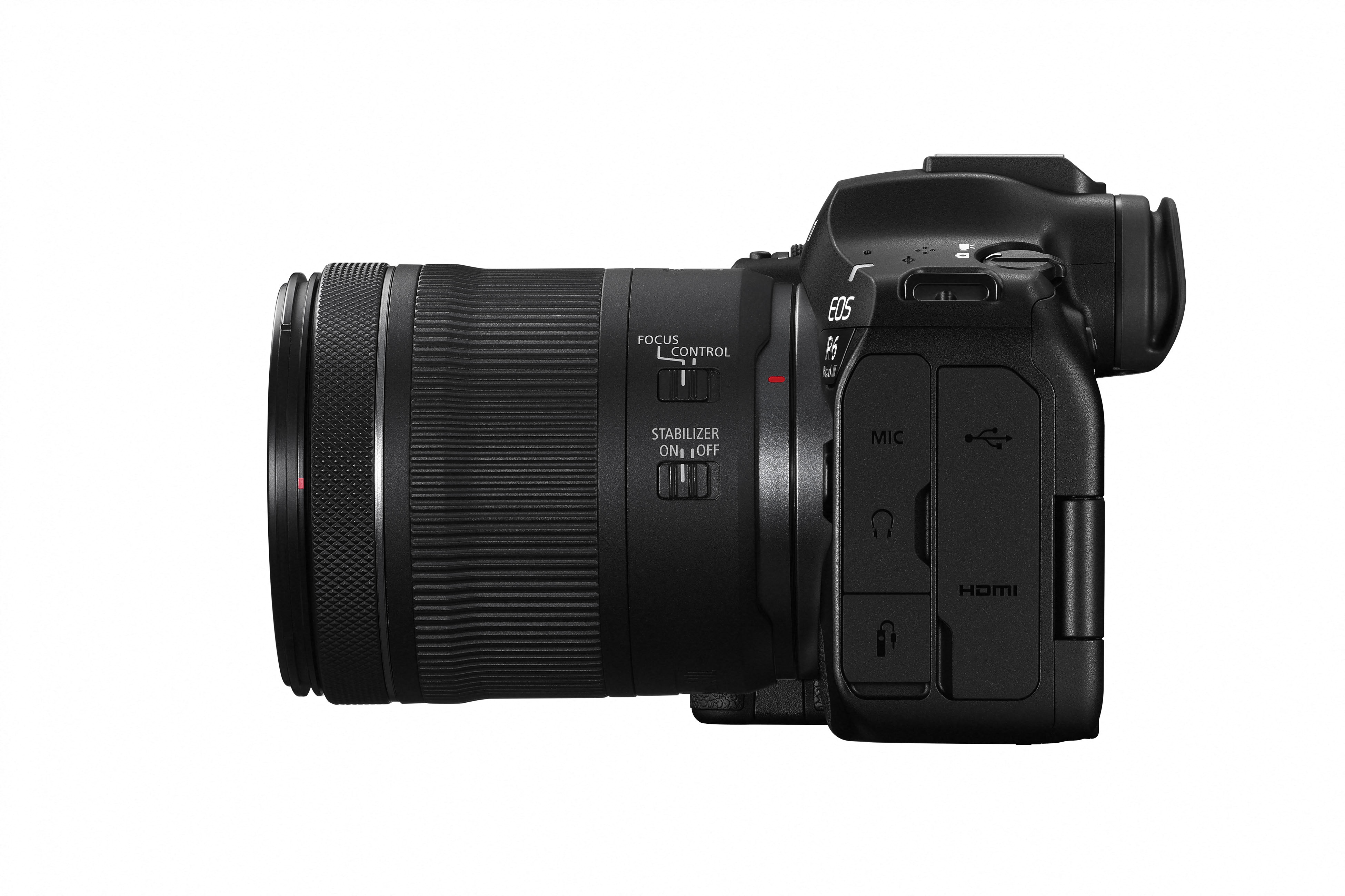Schwarze Canon EOS R6 Kamera mit Objektiv, Seitenansicht. Merkmale Objektivsteuerung, Stabilisator-Schalter, Anschlüsse und 'EOS R6'.