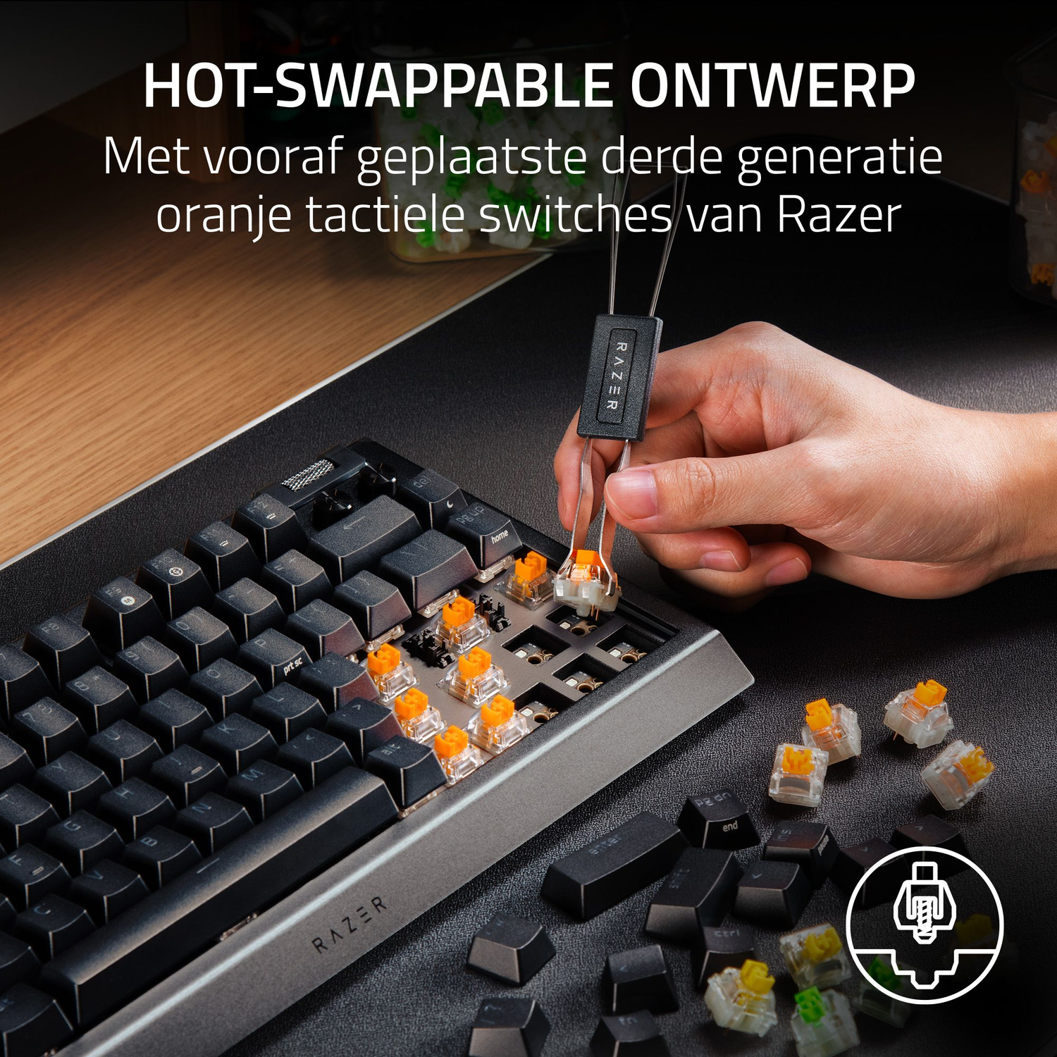 A hand using tweezers to remove an orange switch from a keyboard. Black keys, a silver frame, and scattered keys are visible.