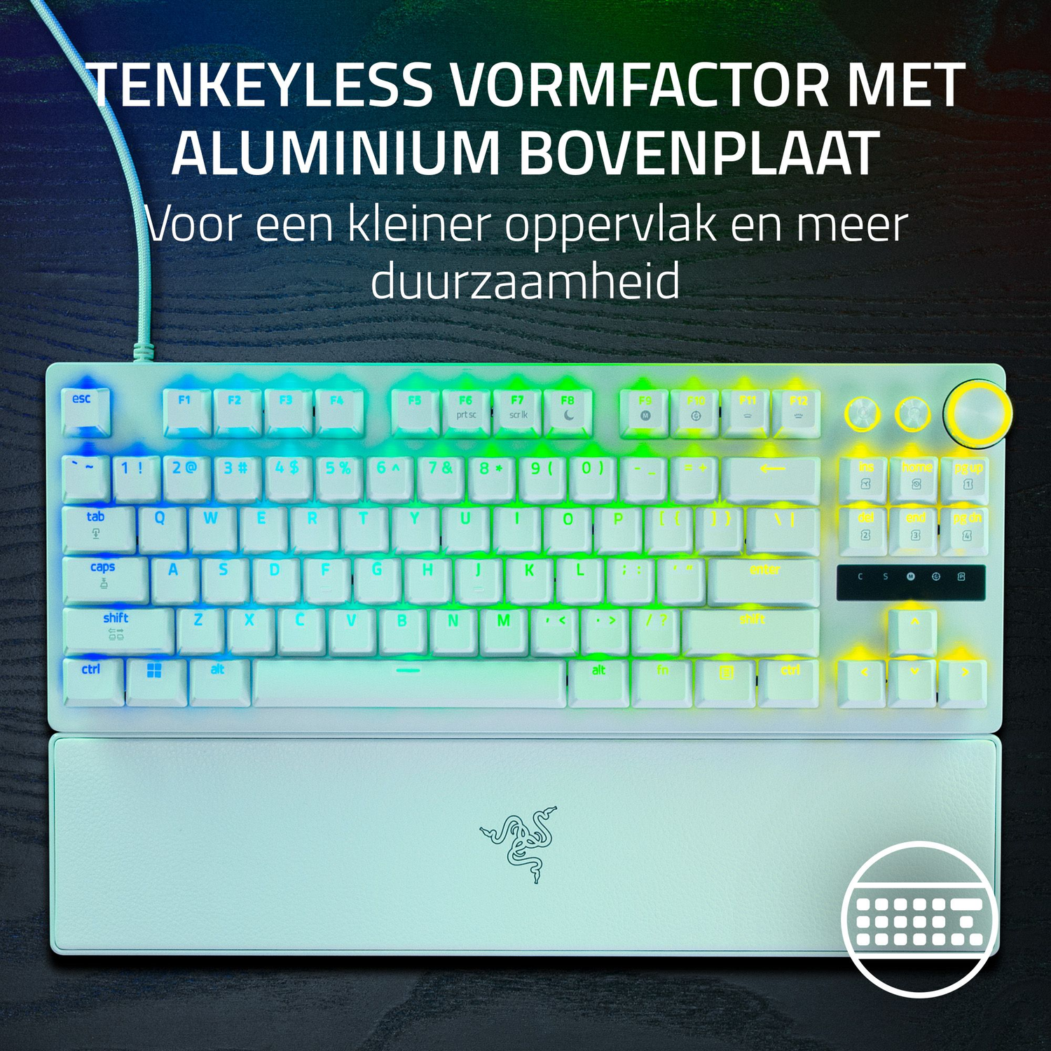 White keyboard with rainbow backlight and wrist rest. Has a Razer logo. Text at top says 'TENKEYLESS VORMFACTOR'.