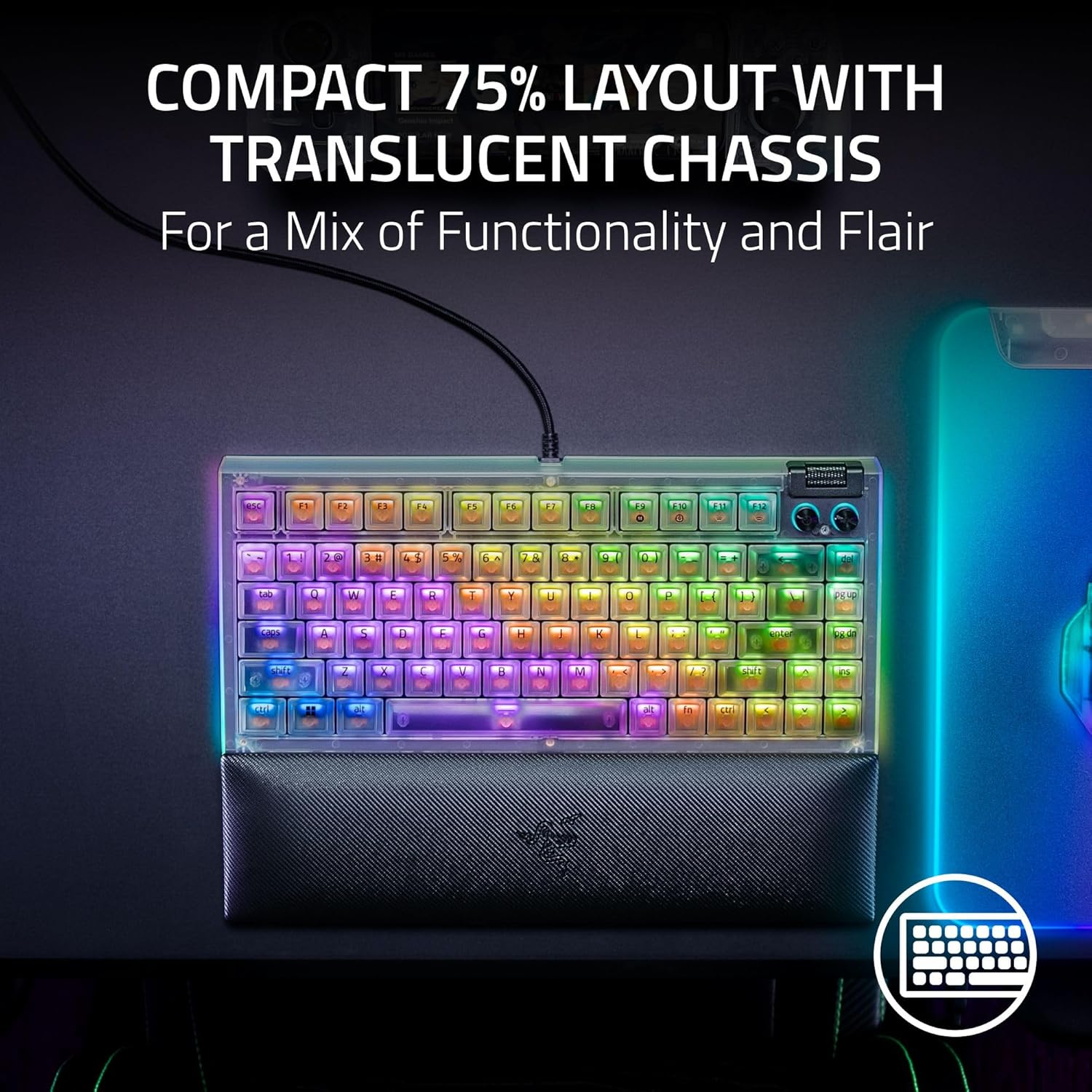 A compact keyboard with a translucent chassis and colorful backlit keys, sitting on a wrist rest. The background is dark.