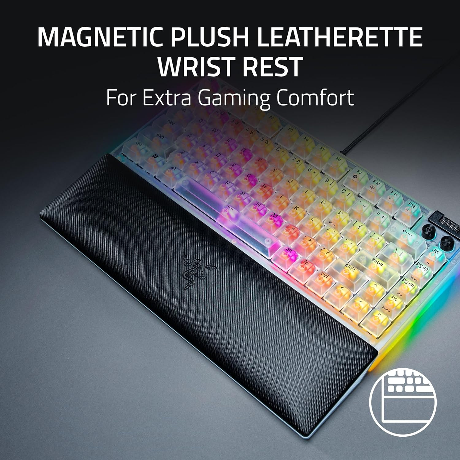A gaming keyboard with a magnetic wrist rest. The keyboard is lit with multiple colors. The wrist rest is black and has the Razer logo.