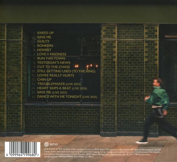 Albumcover. Ein Mann läuft an einer Backsteinmauer vorbei. Text listet Songtitel auf. Unten ist ein Barcode.