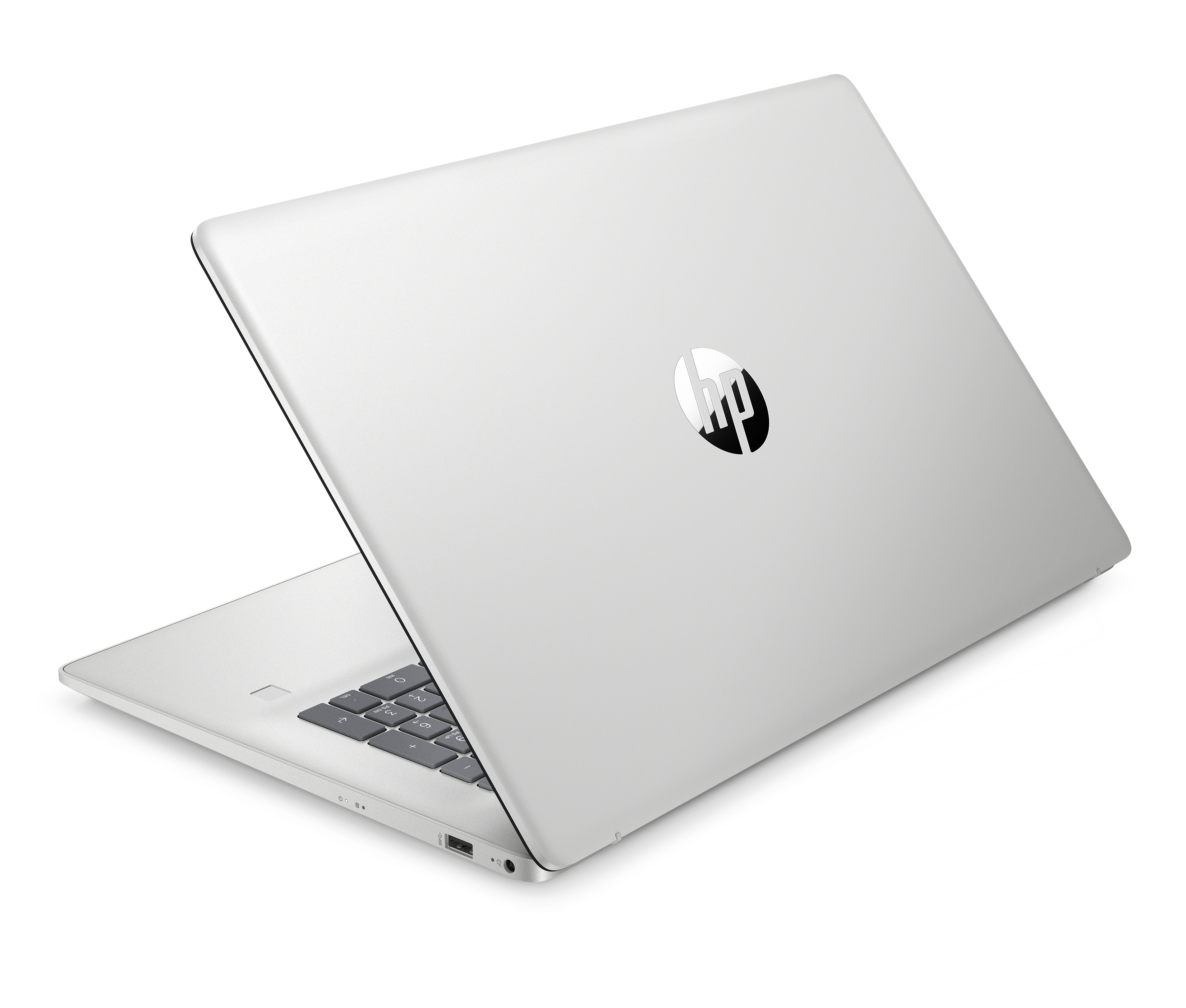 Srebrny laptop, otwarty, na czarnej powierzchni. Widoczne logo HP. Częściowo widoczna klawiatura. Czarne tło.