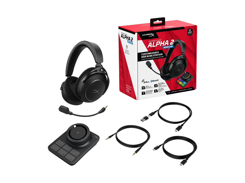 Fekete HyperX Cloud Alpha 2 vezeték nélküli gaming headset, doboz, bázisállomás és kábelek fehér háttéren.