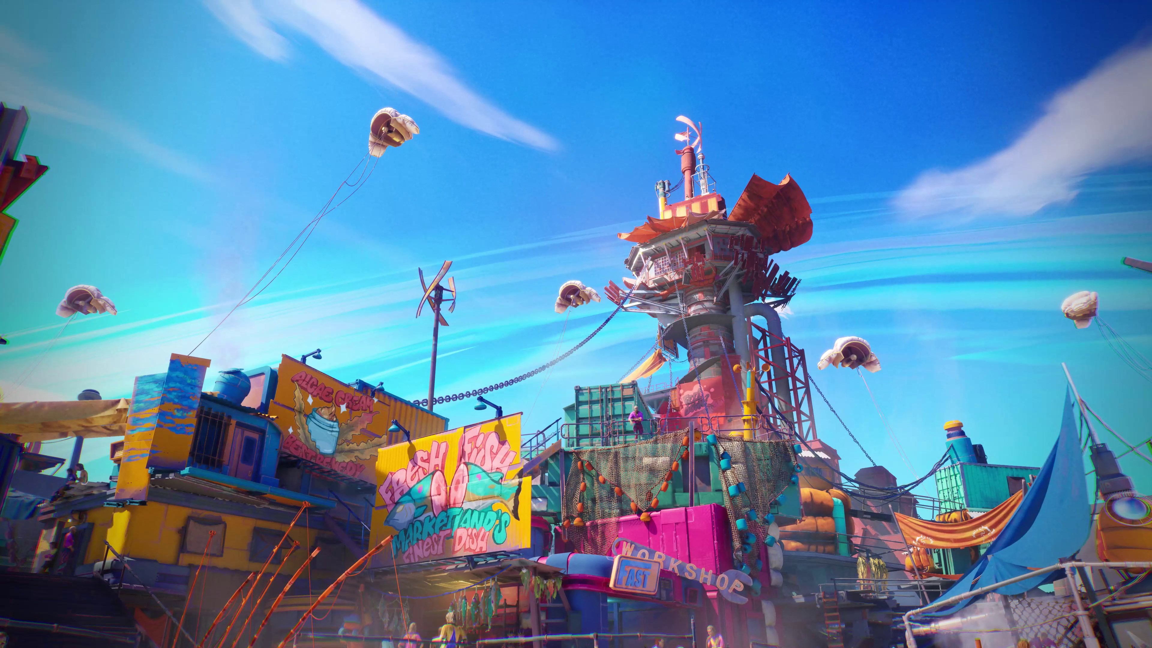 Bunte Gebäude mit Schildern, Ballons und einer zentralen Struktur unter strahlend blauem Himmel. Mehrere Objekte schweben am Himmel.