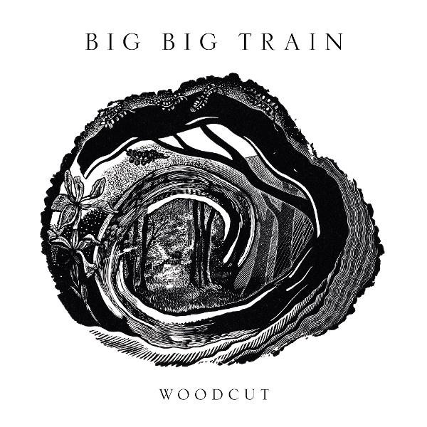 Schwarz-Weiß-Holzschnitt eines Baumrings mit einer Waldszene im Inneren. Text oben: 'BIG BIG TRAIN', unten: 'WOODCUT'.