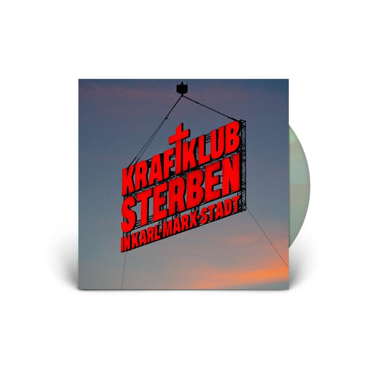 Albumcover: Rotes Schild 'KRAFTKLUB STERBEN IN KARL MARX STADT' vor Dämmerungshimmel. Rechts eine Schallplatte.