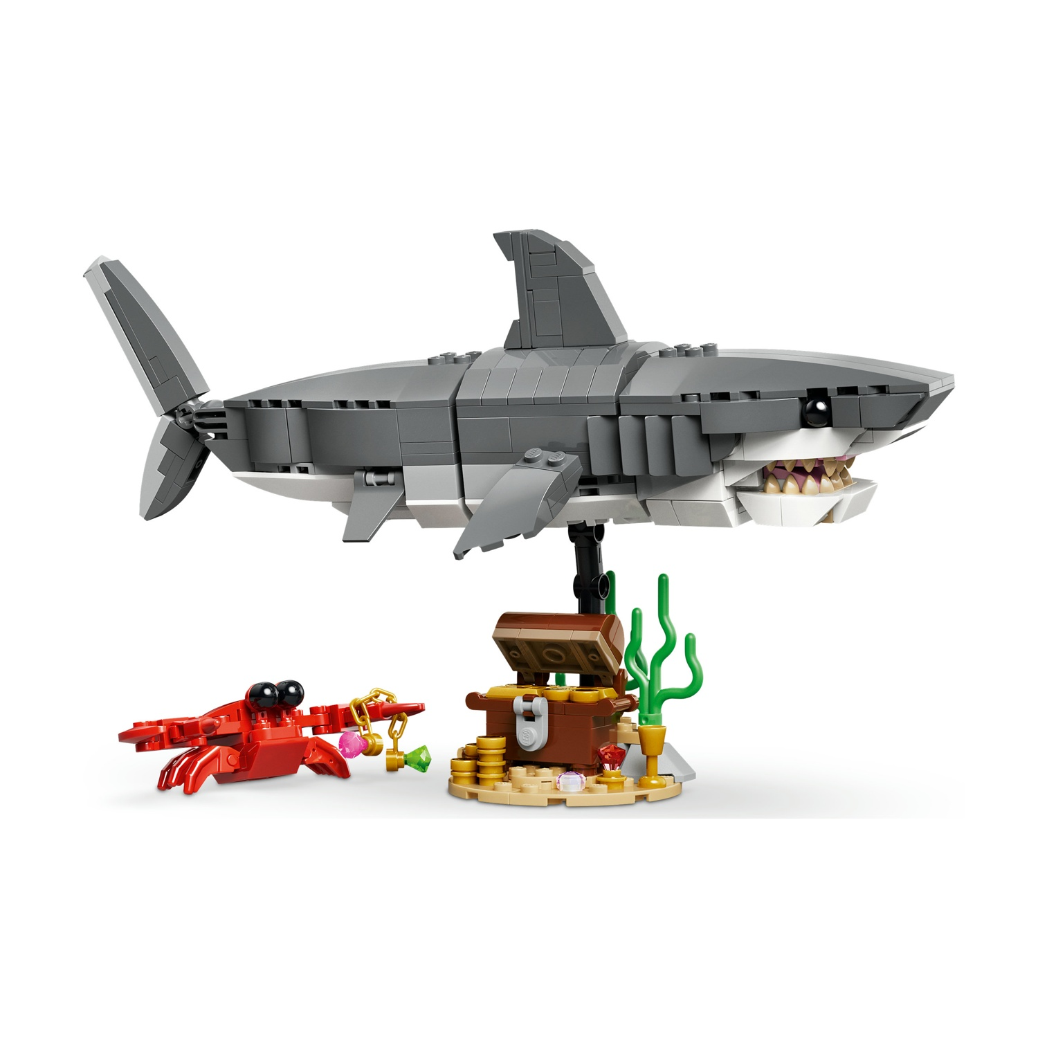 Un set Lego mostra un grande squalo sopra un forziere con un granchio che tiene dei gioielli.