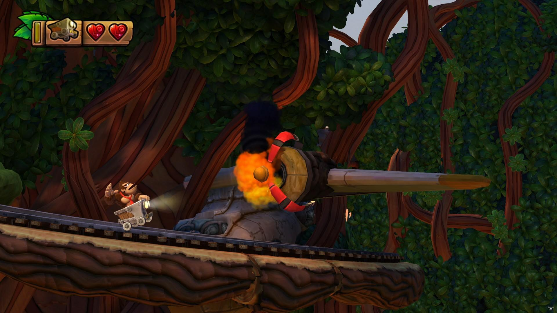 Donkey Kong w wózku górniczym zbliża się do płonącej śmigła. Zielone liście i brązowe drzewa otaczają tor.