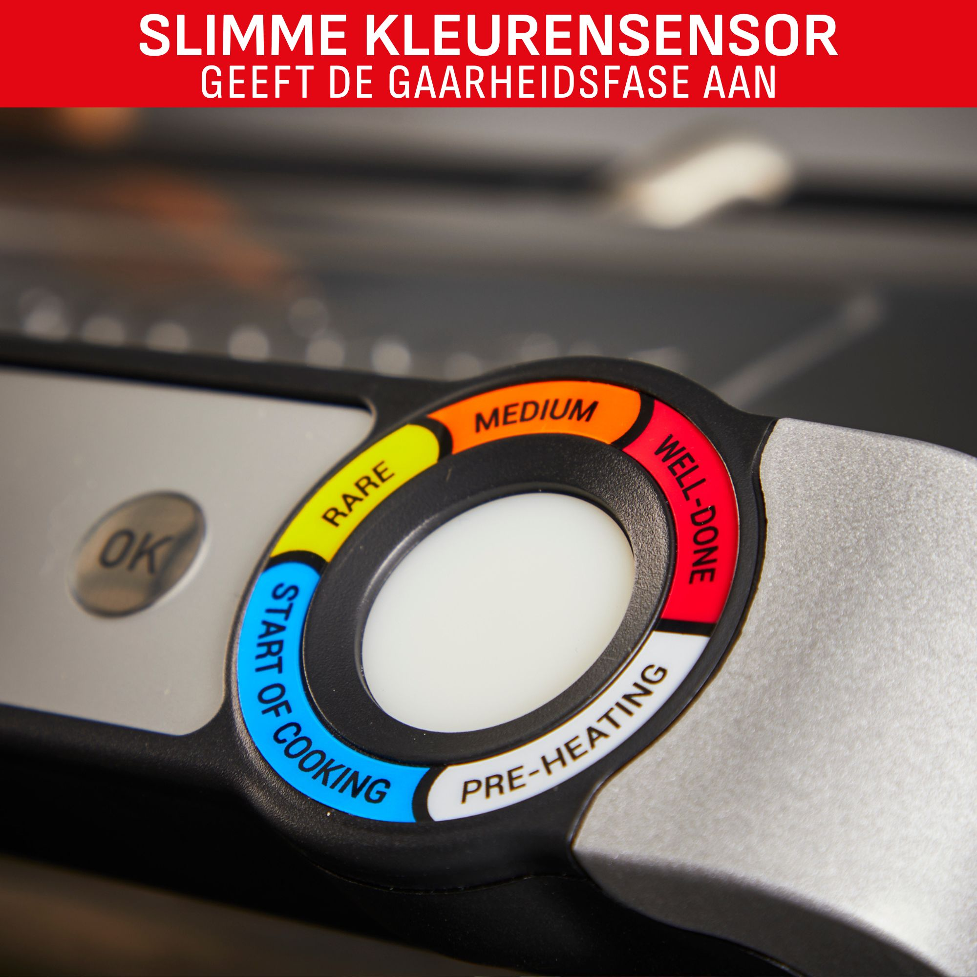 Close-up of a cooking device with a color-coded dial indicating cooking stages: rare, medium, well-done, pre-heating, and start of cooking.