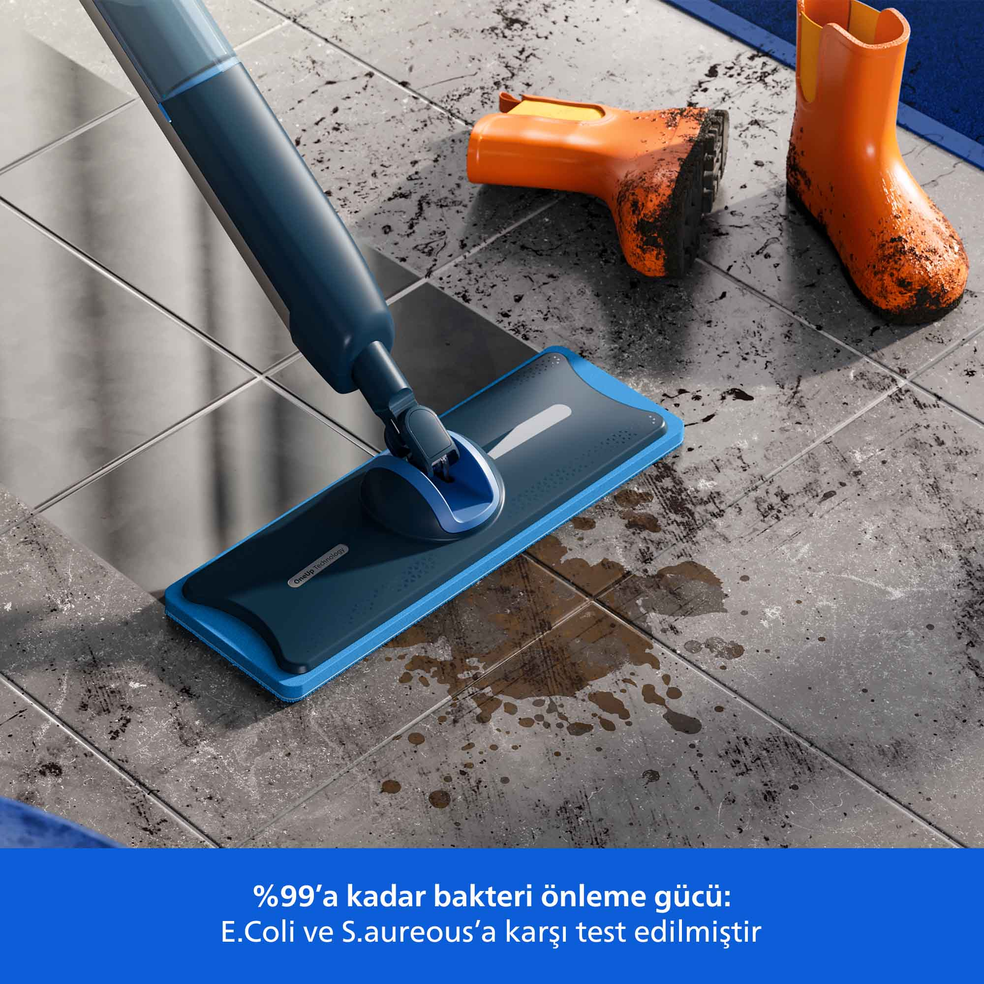 Bir paspas, turuncu çizmelerin yanında kirli bir zemini temizler. Zemin kir ve su ile gridir. Paspas mavidir.