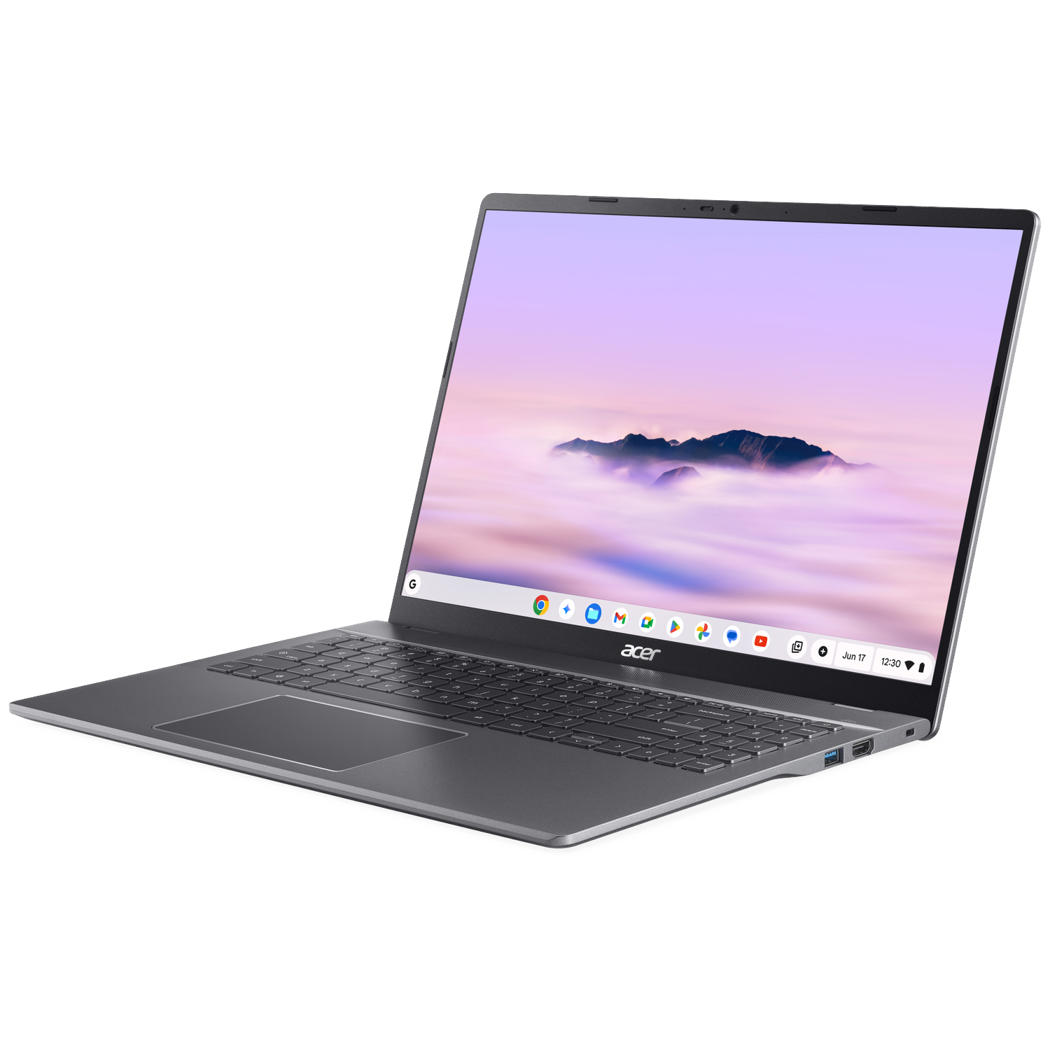 A gray Acer laptop is open, displaying a mountain scene on the screen. The keyboard is visible, with the Acer logo below.