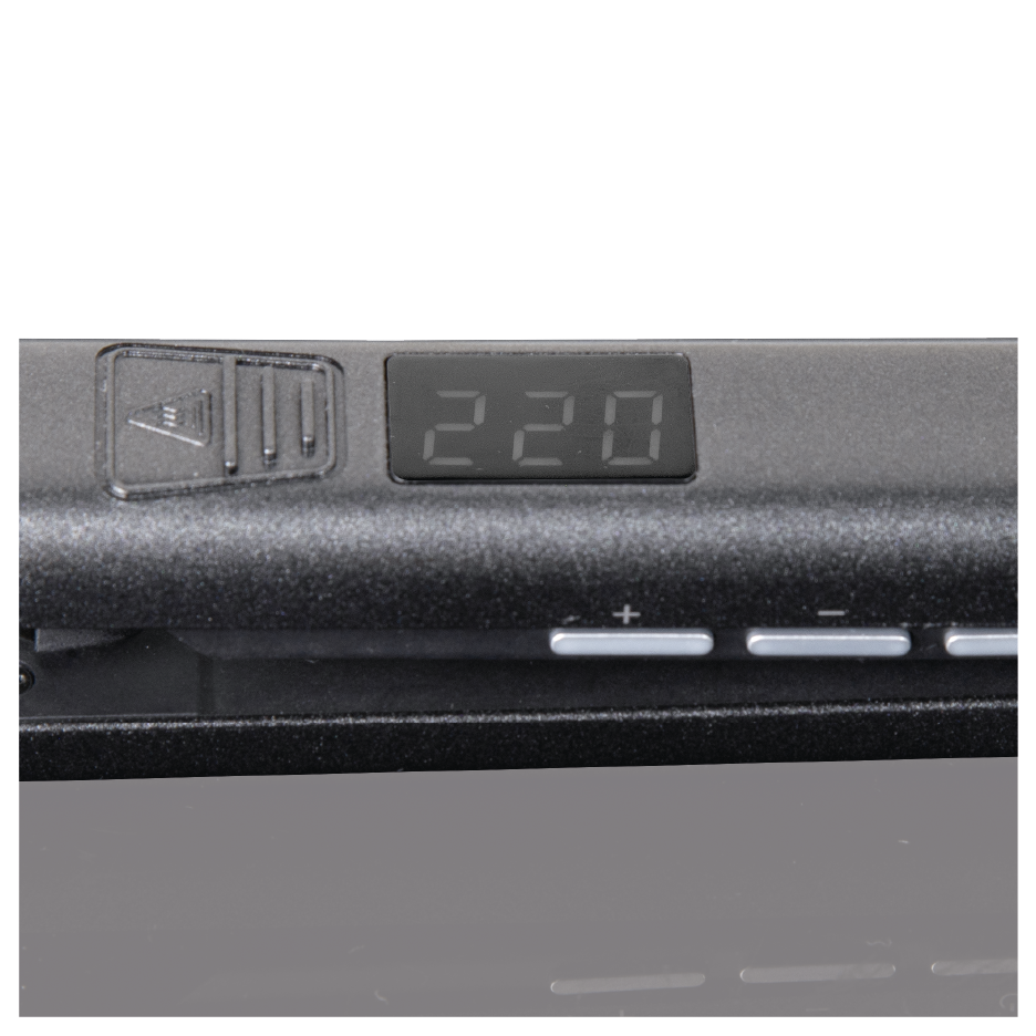 Zbliżenie czarnego urządzenia z cyfrowym wyświetlaczem pokazującym '220'. Widoczne są przyciski i ikona. Urządzenie odbija światło.
