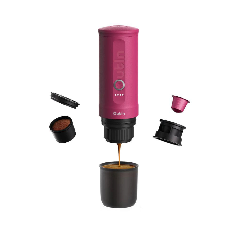 Ein rosa Outin-Kaffeezubereiter, der Kaffee in eine Tasse abgibt. Komponenten und Kaffeekapseln sind vorhanden.