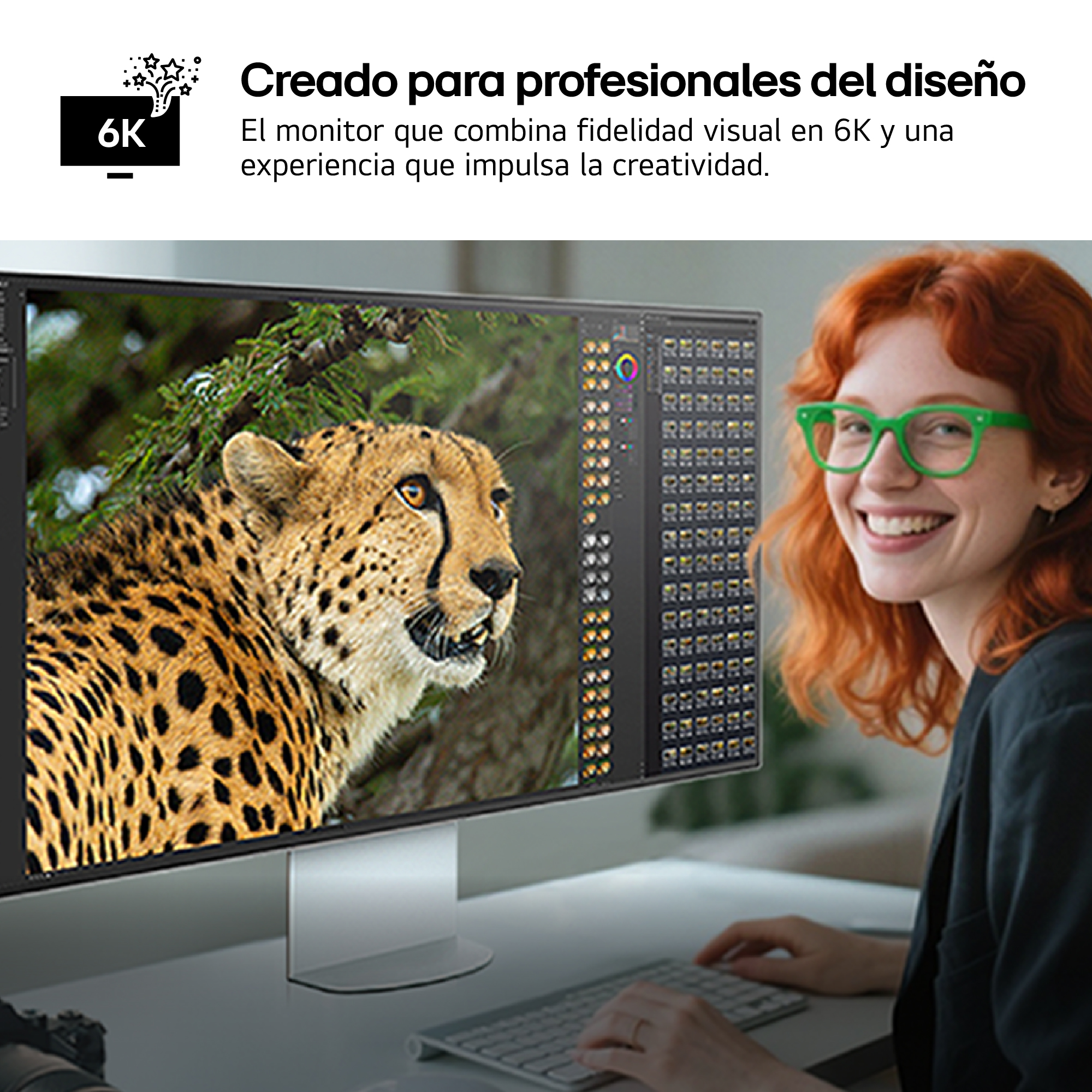Una mujer con cabello rojo y gafas verdes sonríe a la cámara; un monitor 6K muestra un guepardo.