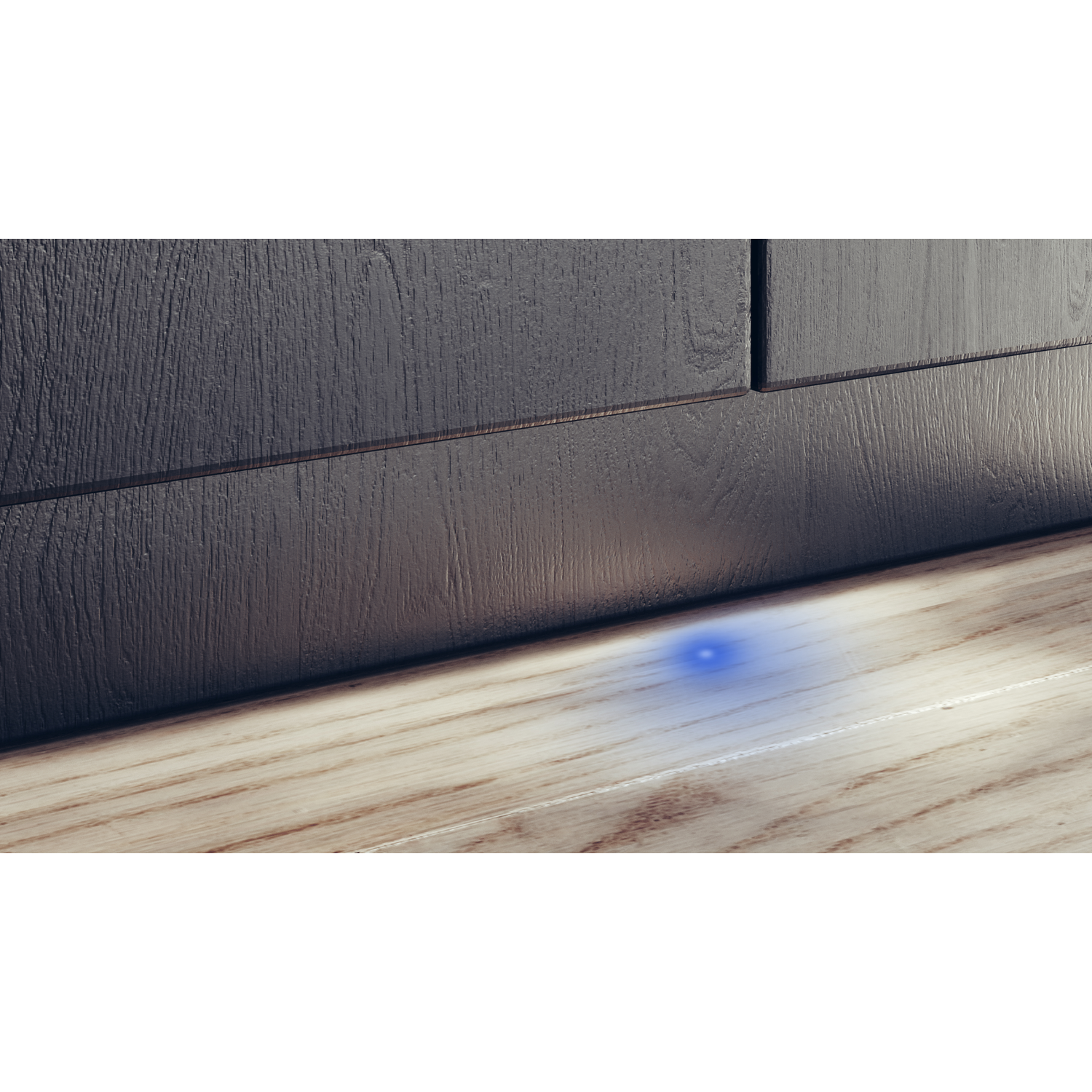 Wooden floor with a blue light spot, dark wooden wall in the background.