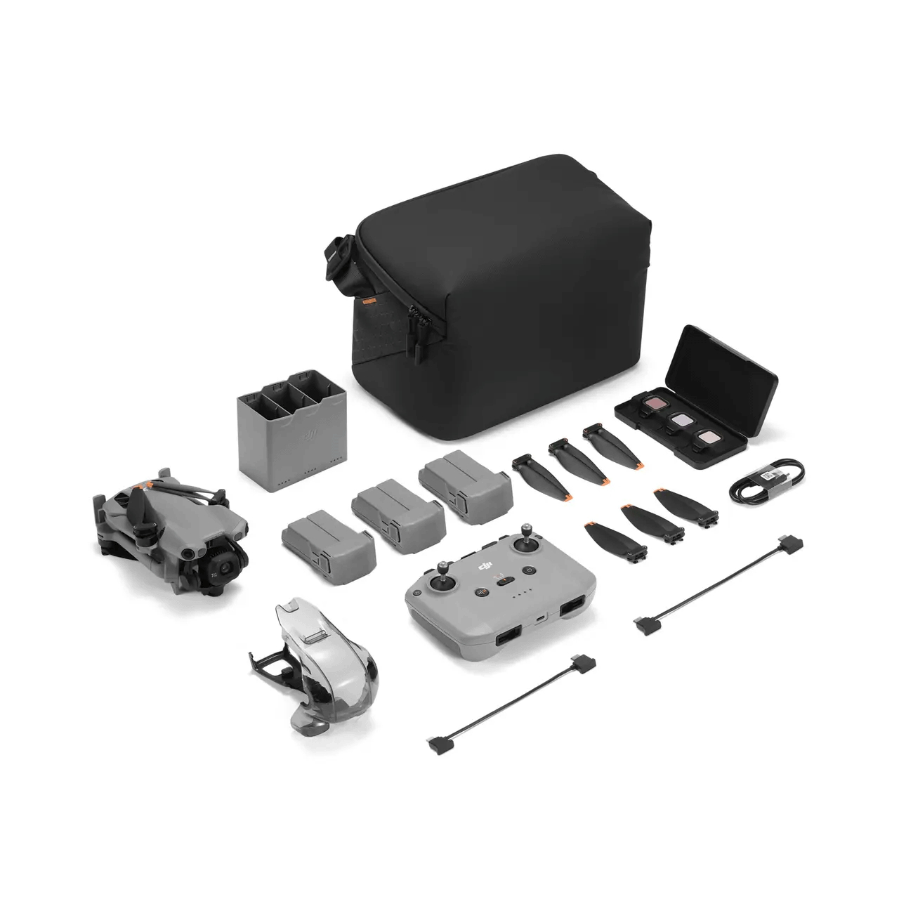 Drohnen-Kit: Graue Drohne, Akkus, Controller, Koffer, Propeller, Ladegerät und Filter auf weißem Hintergrund.