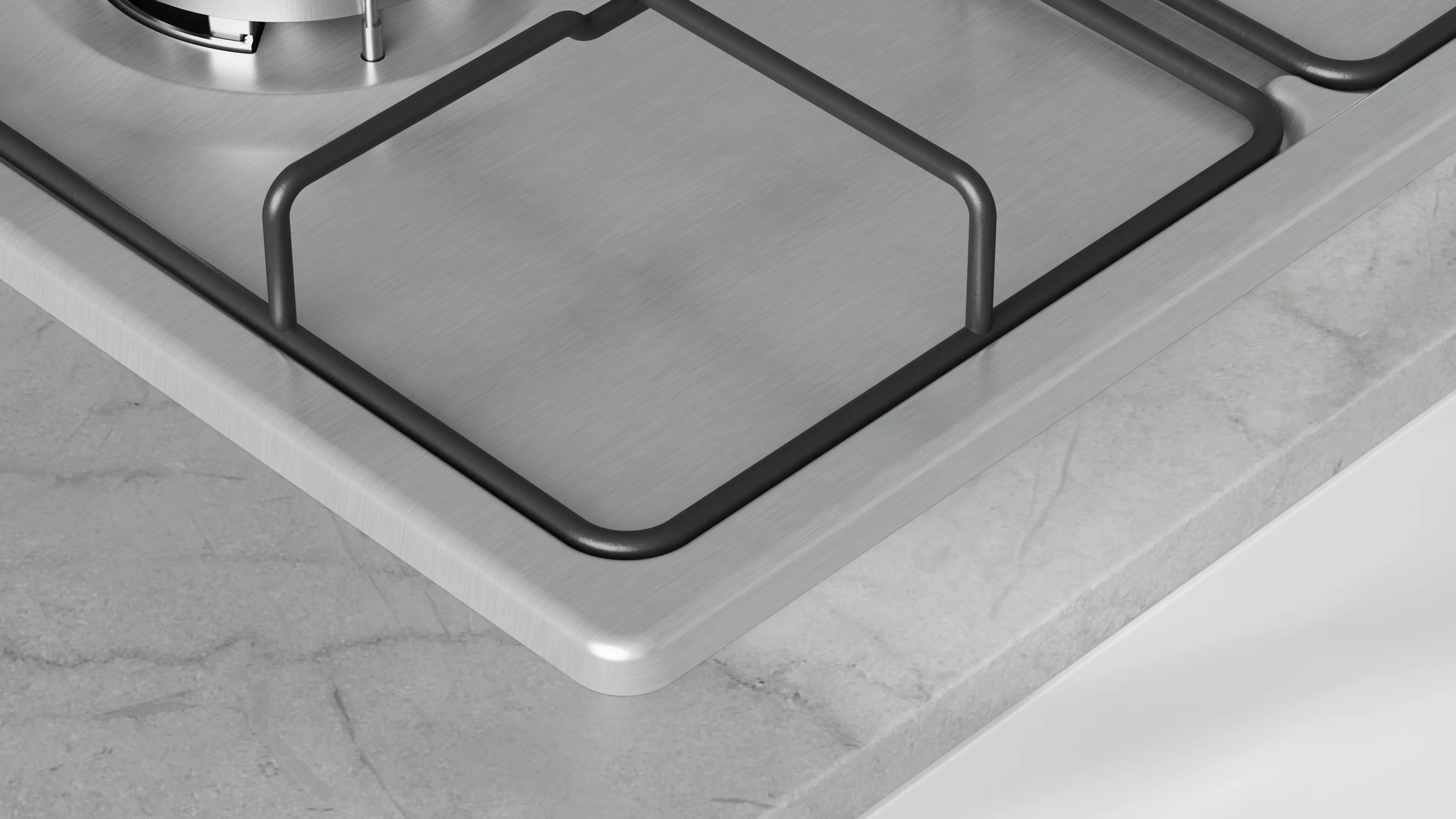 Primer plano de una cocina de gas con superficie metálica y rejillas negras. La encimera es gris con patrón de mármol.