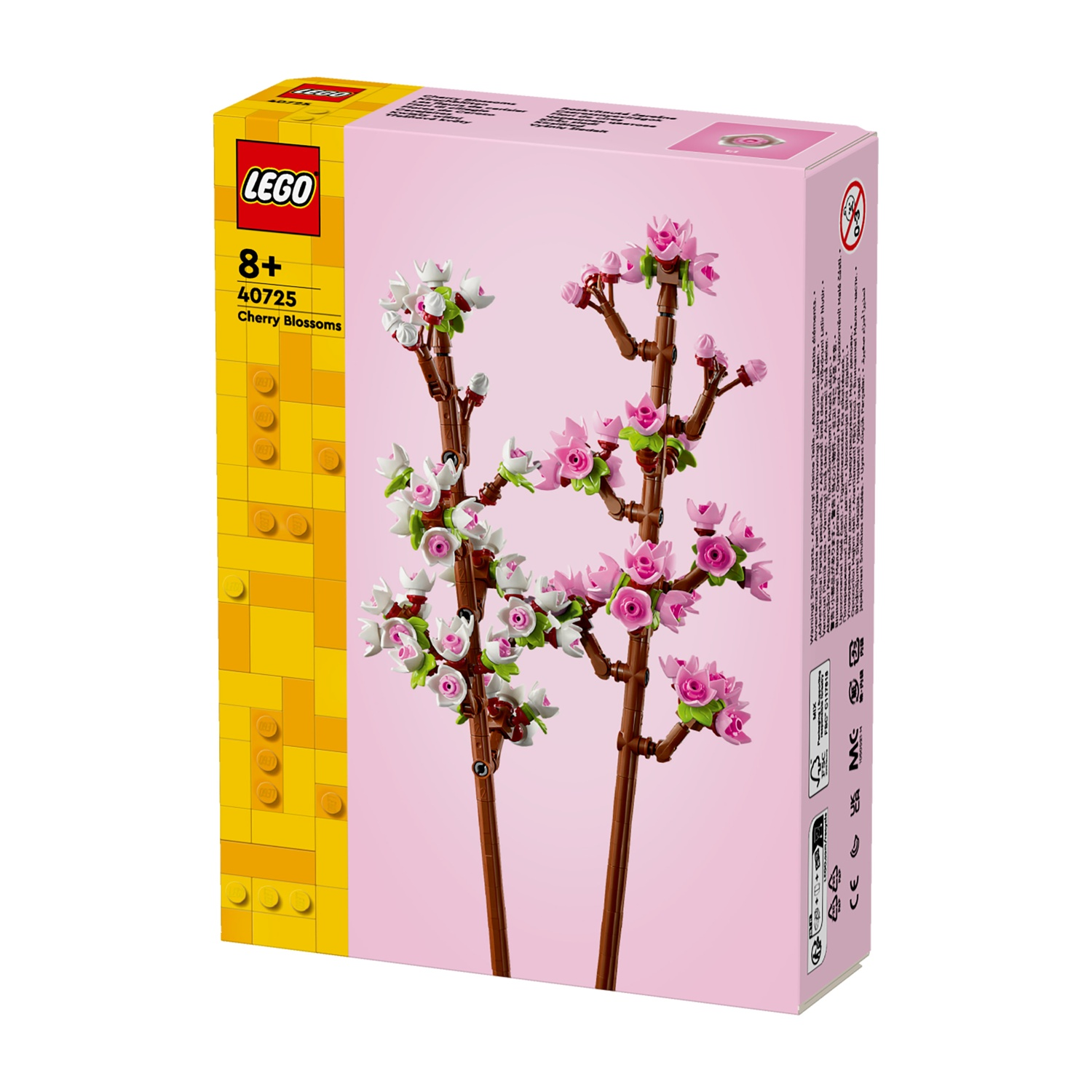 Una scatola Lego mostra un set di fiori di ciliegio. Presenta fiori rosa, rami marroni e una sezione gialla con il logo Lego.