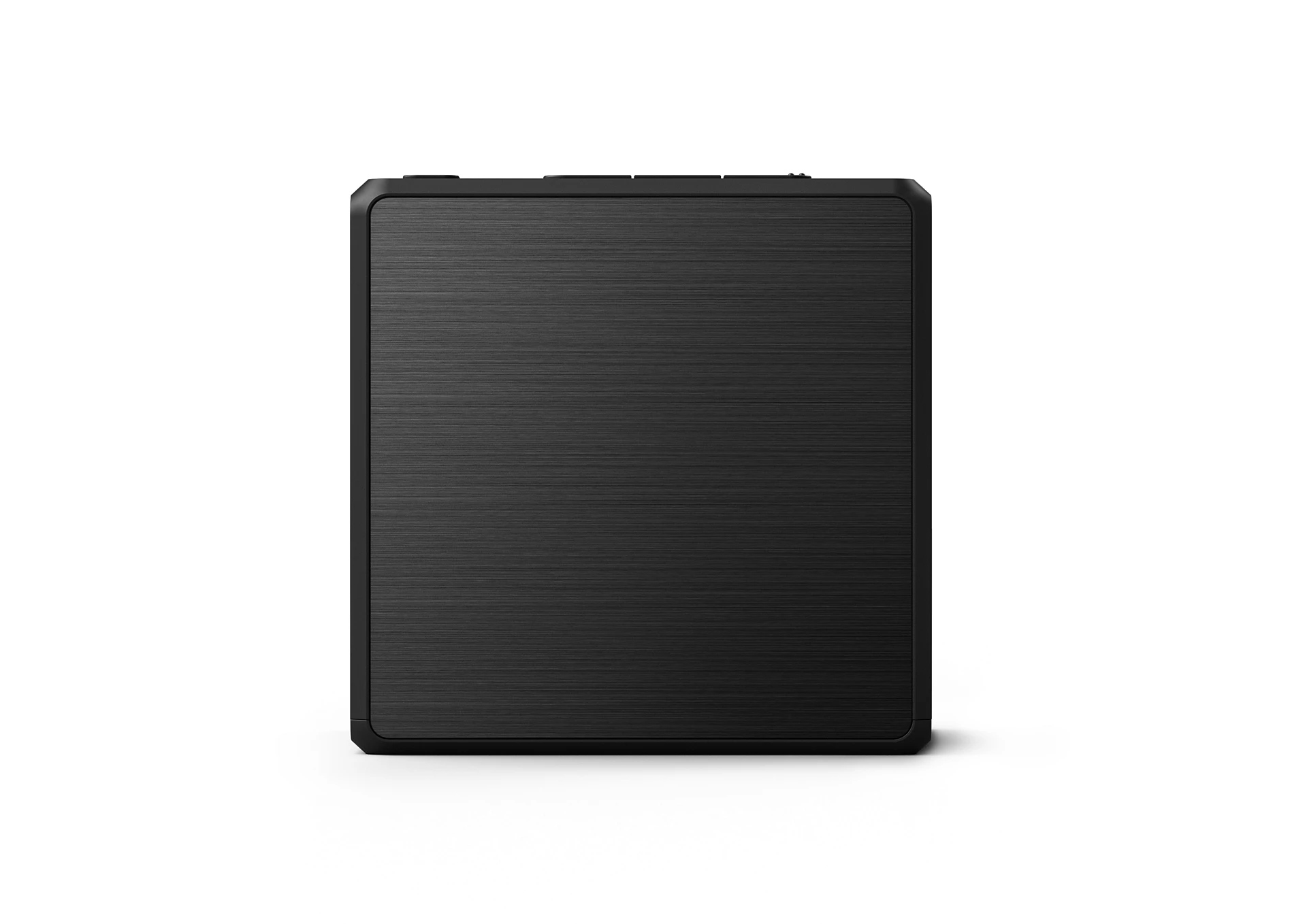 Un dispositivo rectangular negro con superficie texturizada, posiblemente un reproductor multimedia, sobre fondo blanco.