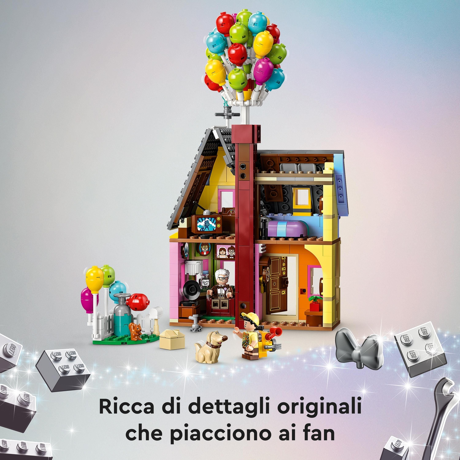 Una casa Lego con palloncini. Personaggi e un cane. La casa è multicolore con sezioni aperte.
