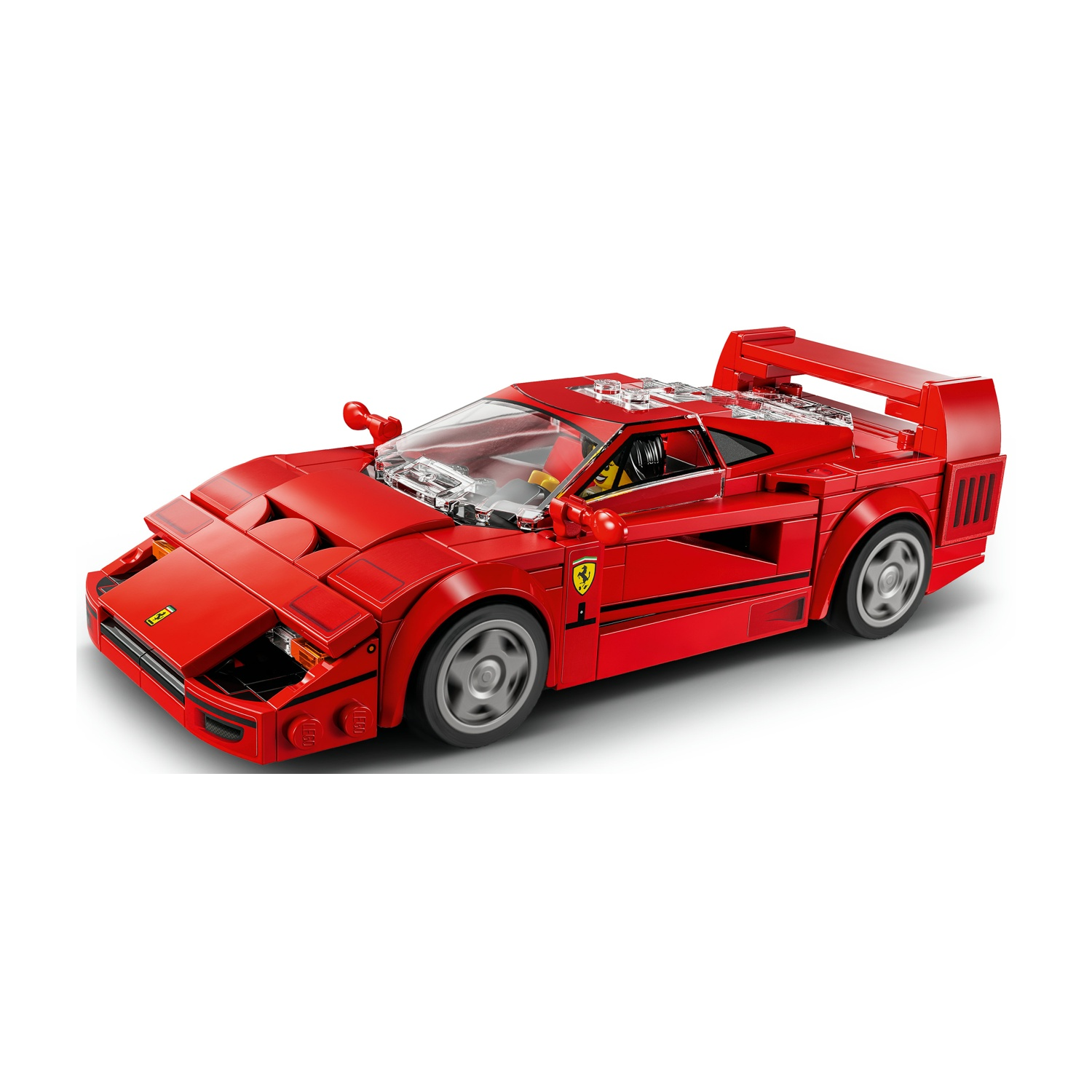 Un modello di auto Ferrari Lego rosso. Ha uno spoiler, ruote grigie e interni neri. Lo sfondo è bianco.
